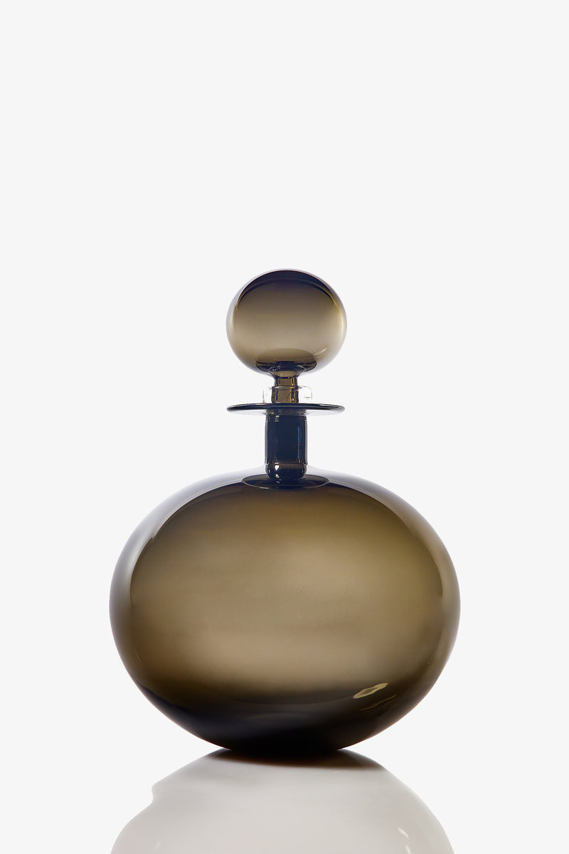 A large, low round decanter made from smoky brown glass with a matching spherical stopper, photographed against a white background.