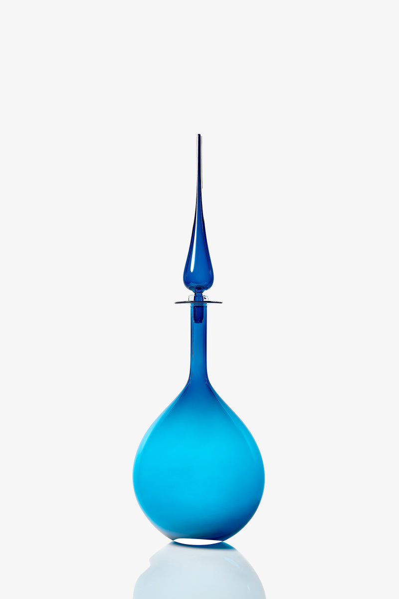 A Large Tear Drop Decanter featuring a tall, elegant blue glass bottle with a teardrop-shaped base and a long, narrow stopper, set against a plain white background.
