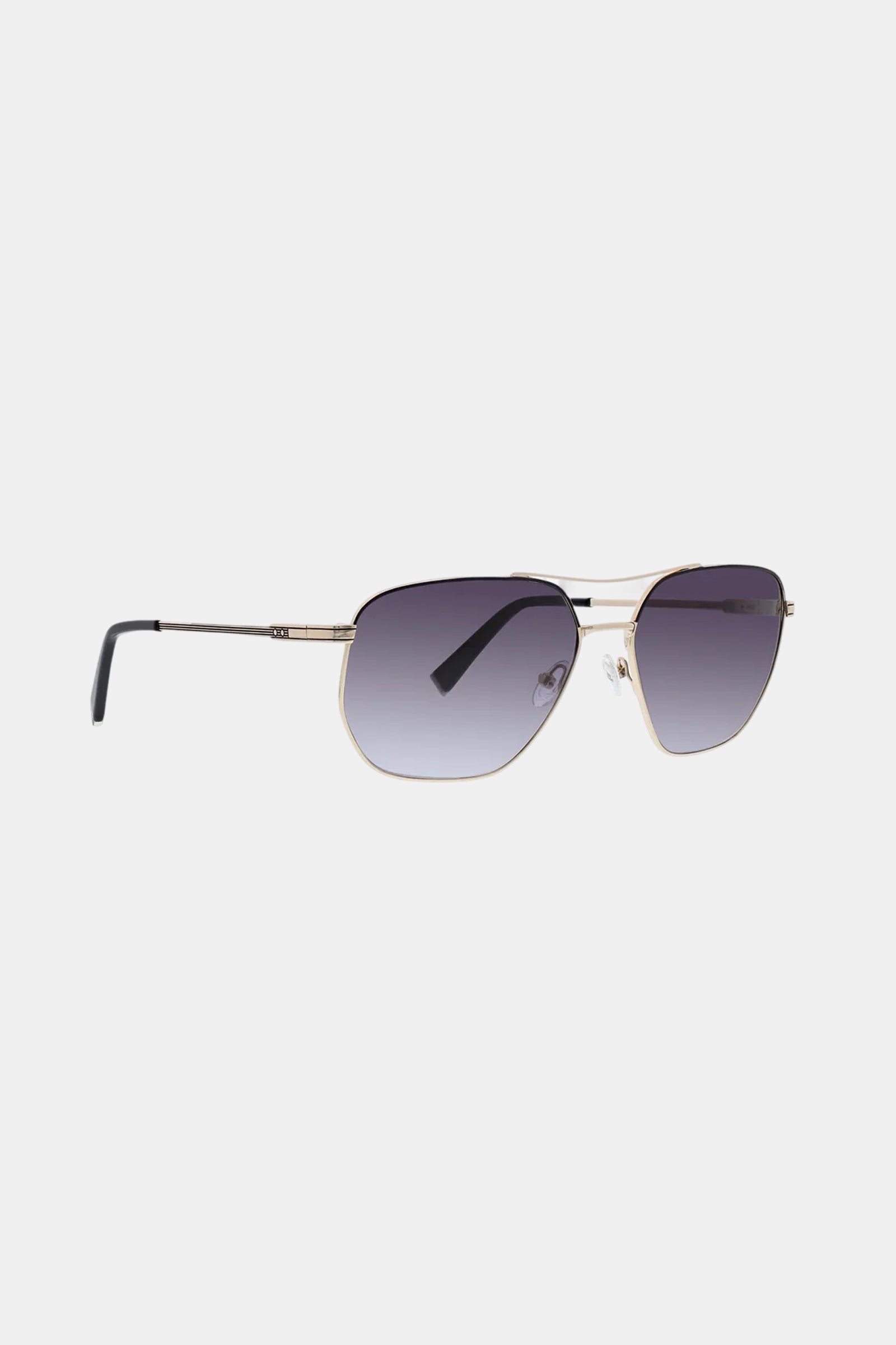 Le Chance Sunglass: gold metal aviator-style frame with black temple tips and gradient dark lenses, shown on a white background.