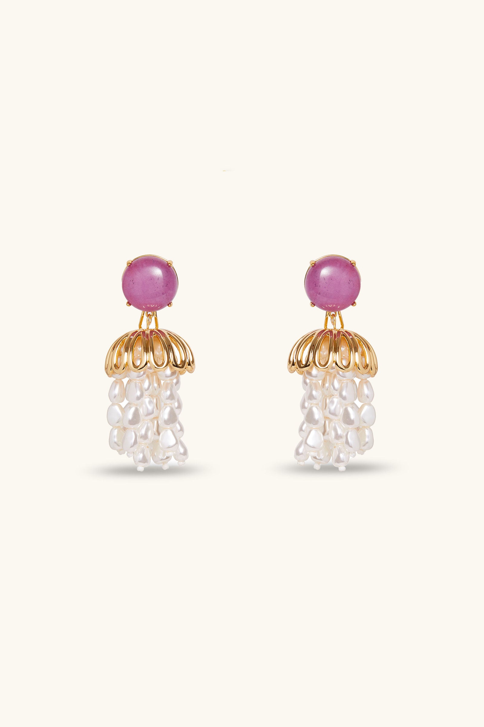 Lele Sadoughi x Trina Turk Parapluie Strand Earrings in lavender feature round stones on top, a gold dome-shaped design below, and clusters of white pearl-like beads hanging beneath, set against a light background.