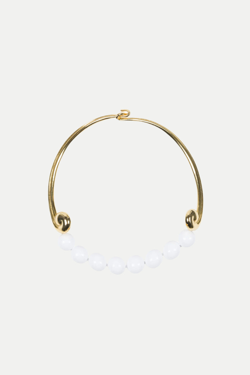 The KJL Beaded White and Gold Collar Necklace features a row of seven white round beads along the bottom, with an open hook clasp.