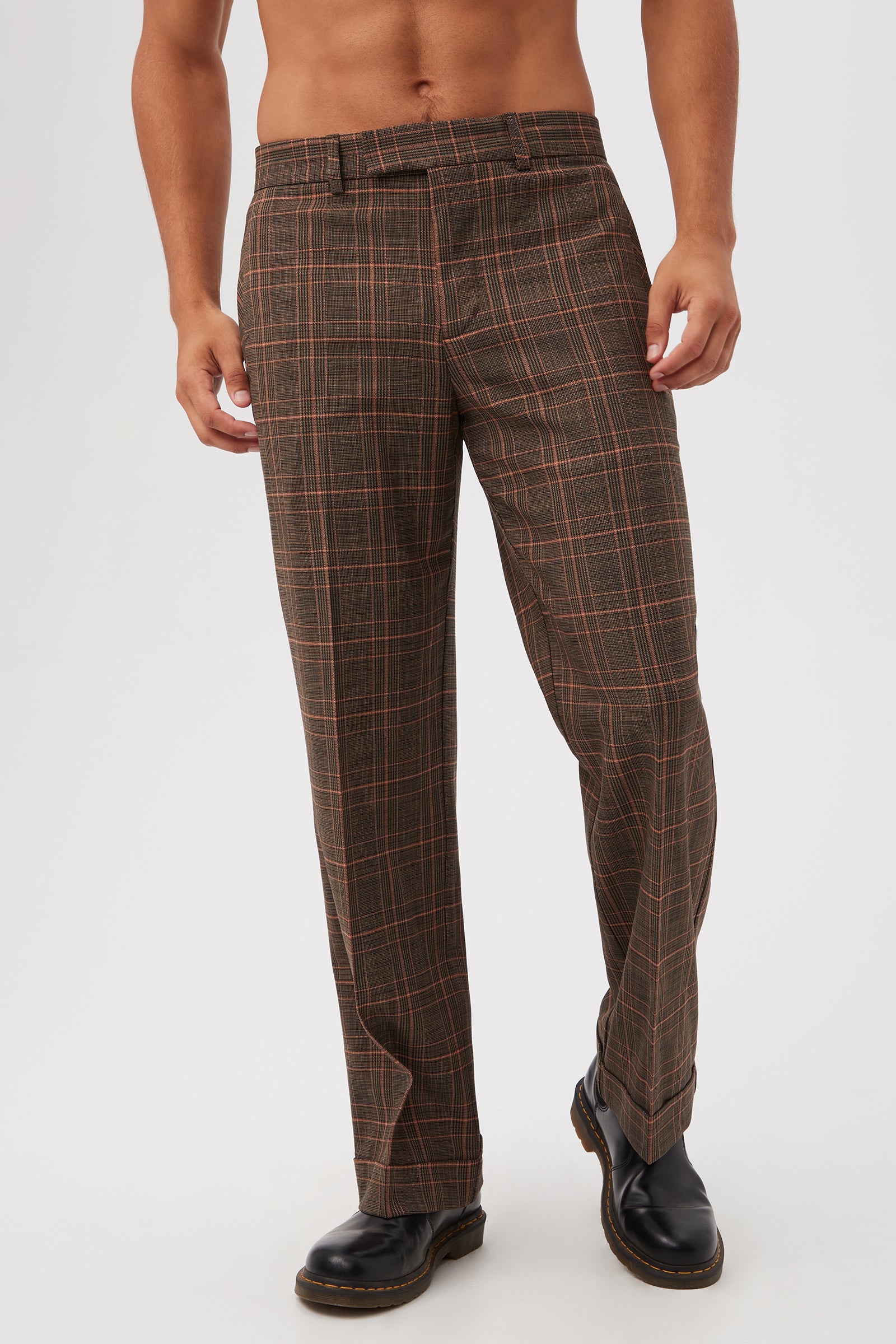 Model shown from mid-chest down wearing Genet Wide-Leg Trousers in Chaka Check Plaid (multi) and black leather boots, against a plain light background.