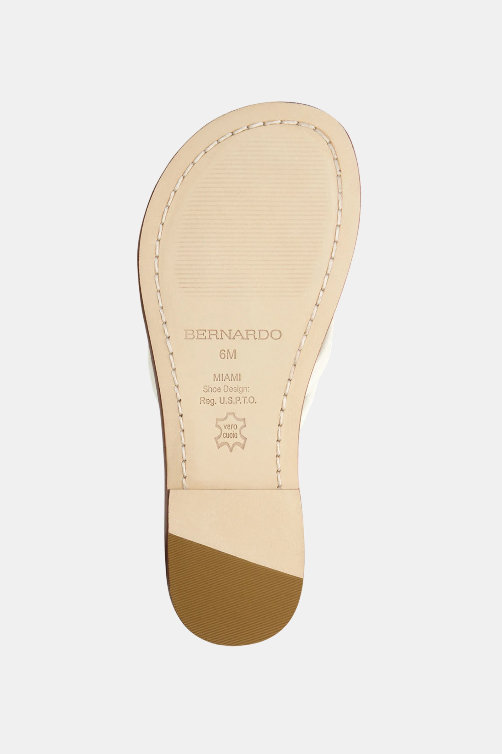 The image shows the beige sole of the Miami Sandal by Bernardo with visible stitching, a brown heel tip, and stamped branding details like size, location, and a star-shaped Vero Cuoio leather stamp.
