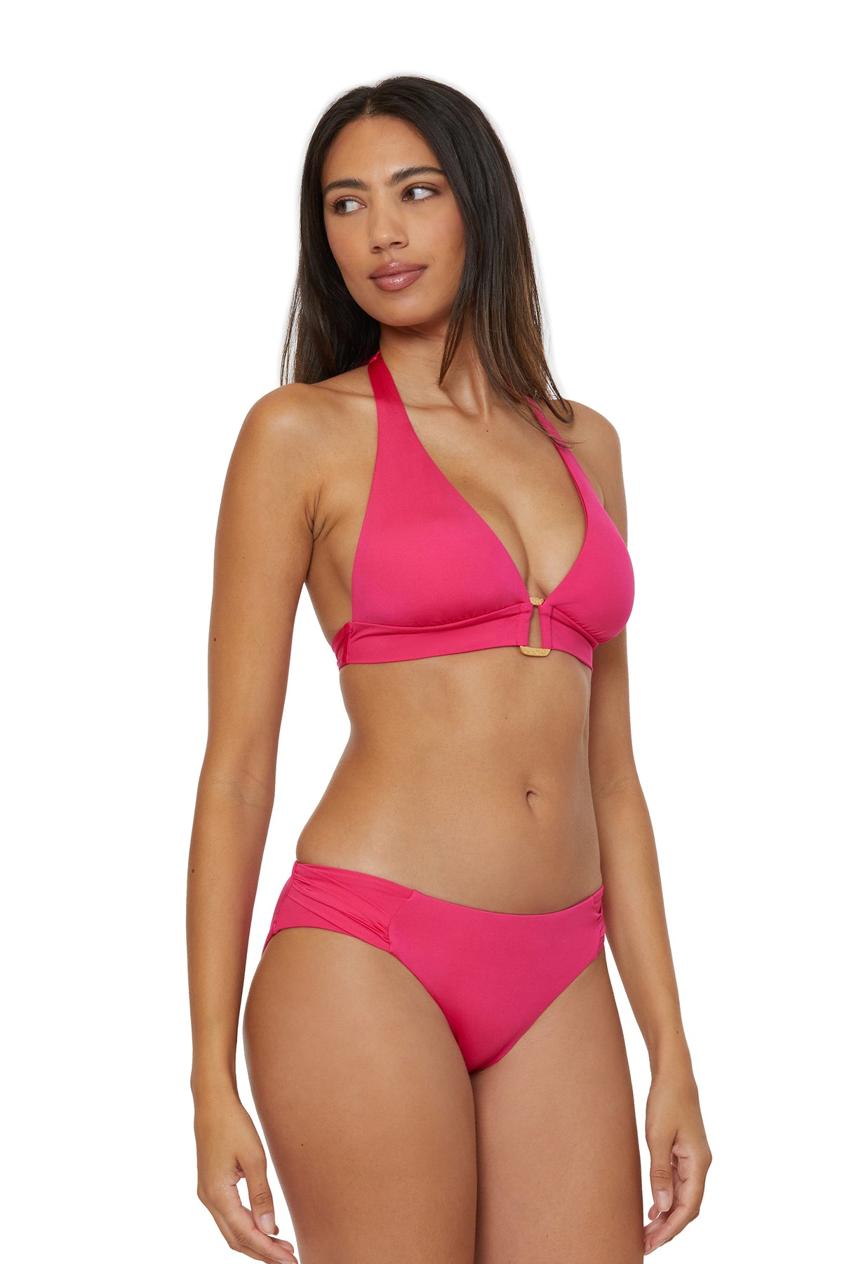 A woman models the Monaco Banded Halter Swim Top in bright pink with matching bottoms, standing against a white background and looking to her left with a neutral expression.