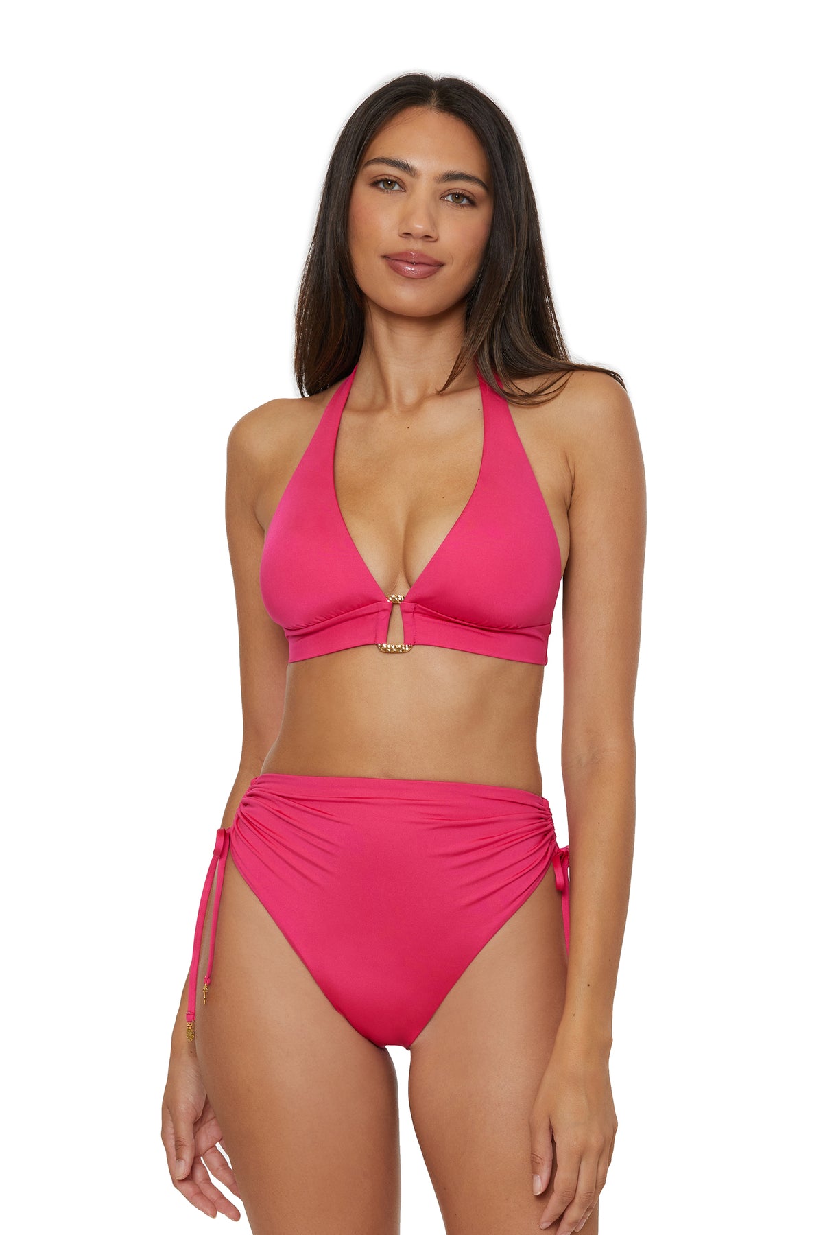 A woman with long dark hair wears a bright pink halter bikini top and Monaco Shirred Tie High-Waist Swim Bottoms, standing against a white background and looking at the camera.