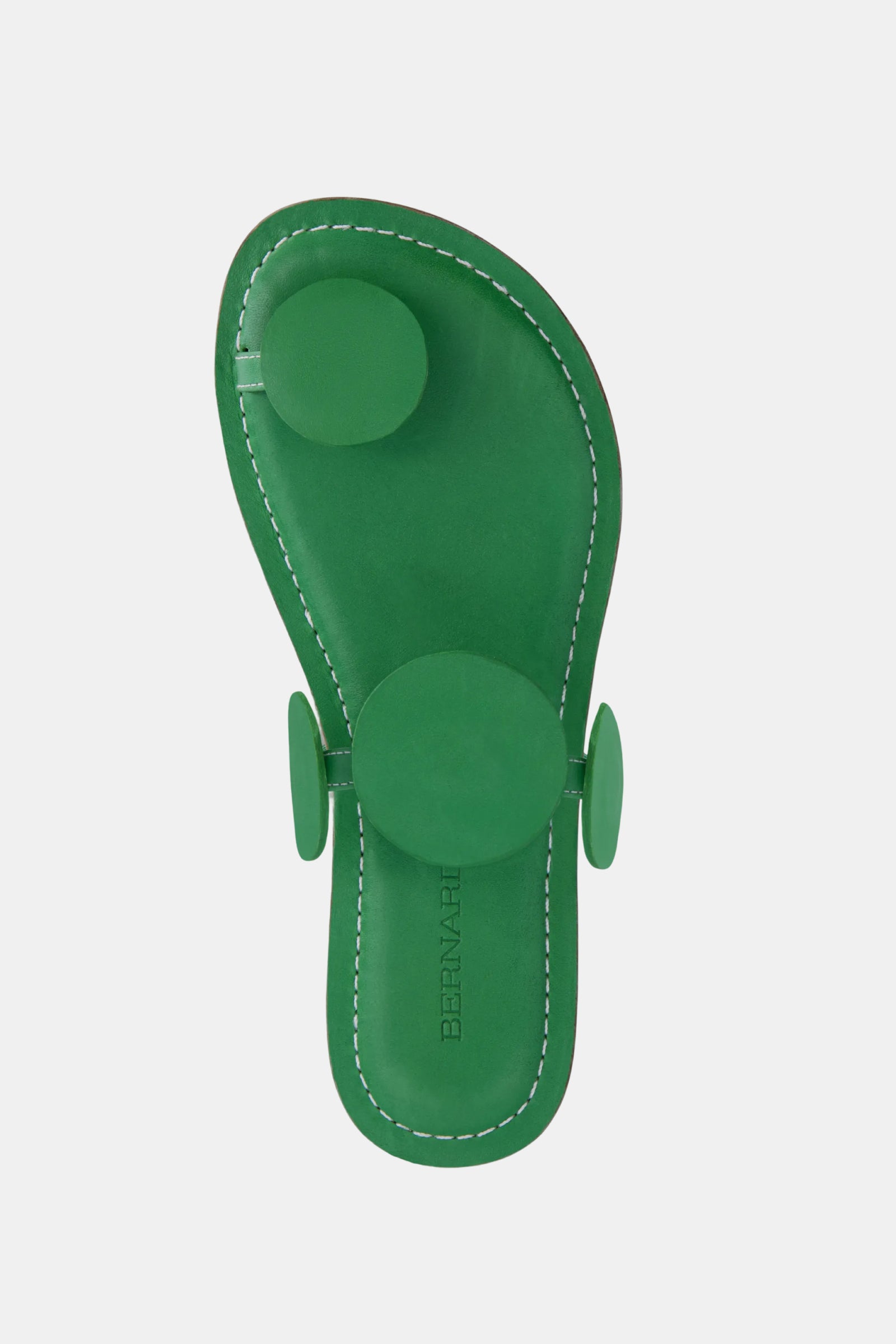The Bernardo New Moon Sandal is a green, minimalist sandal featuring three raised circular accents on the strap and footbed, white edge stitching, and an embossed BERNADETTE logo on the insole.