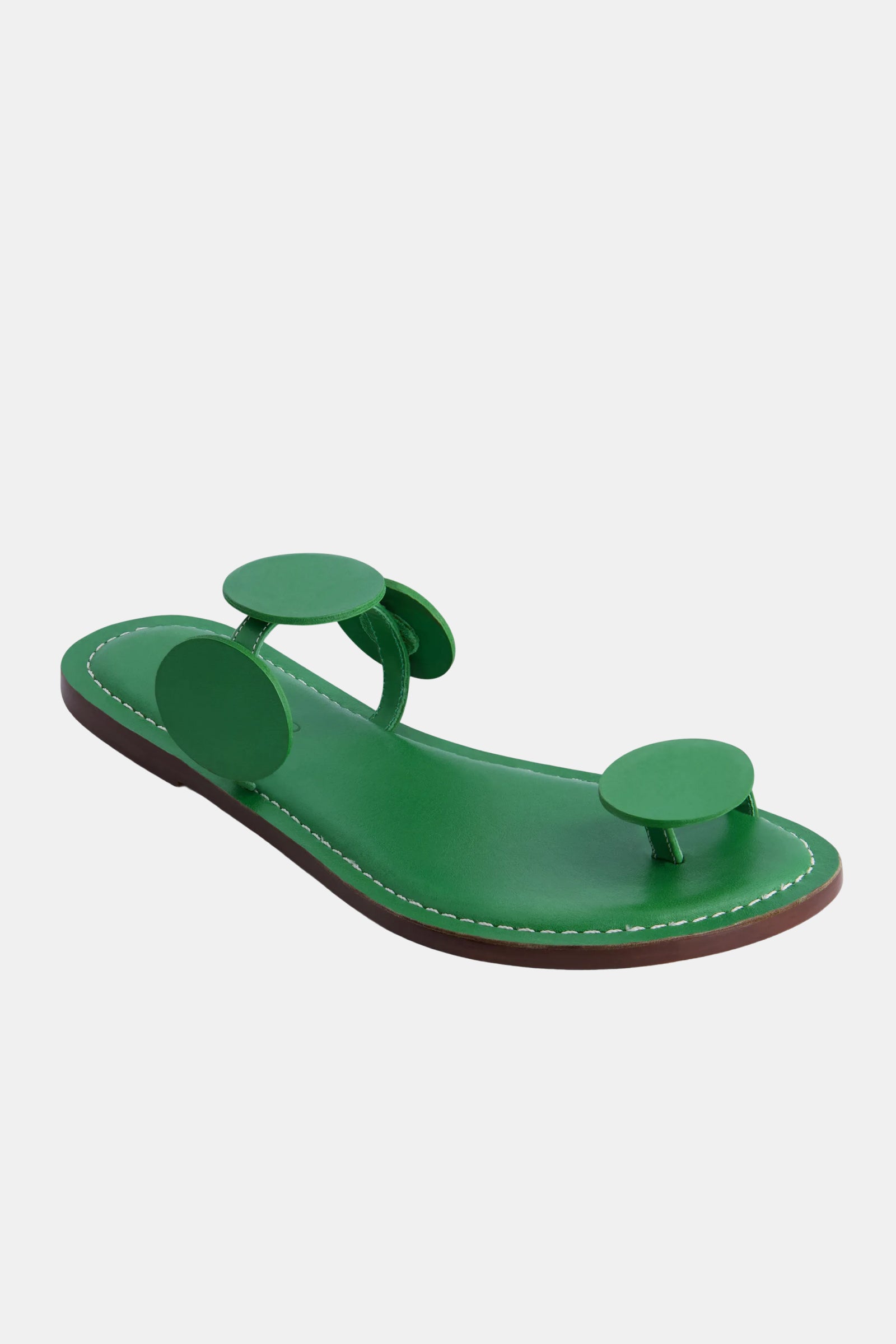 The Bernardo New Moon Sandal features a green leather sole with two large, round green straps—one at the toes and one across the top of the foot—displayed against a plain white background.