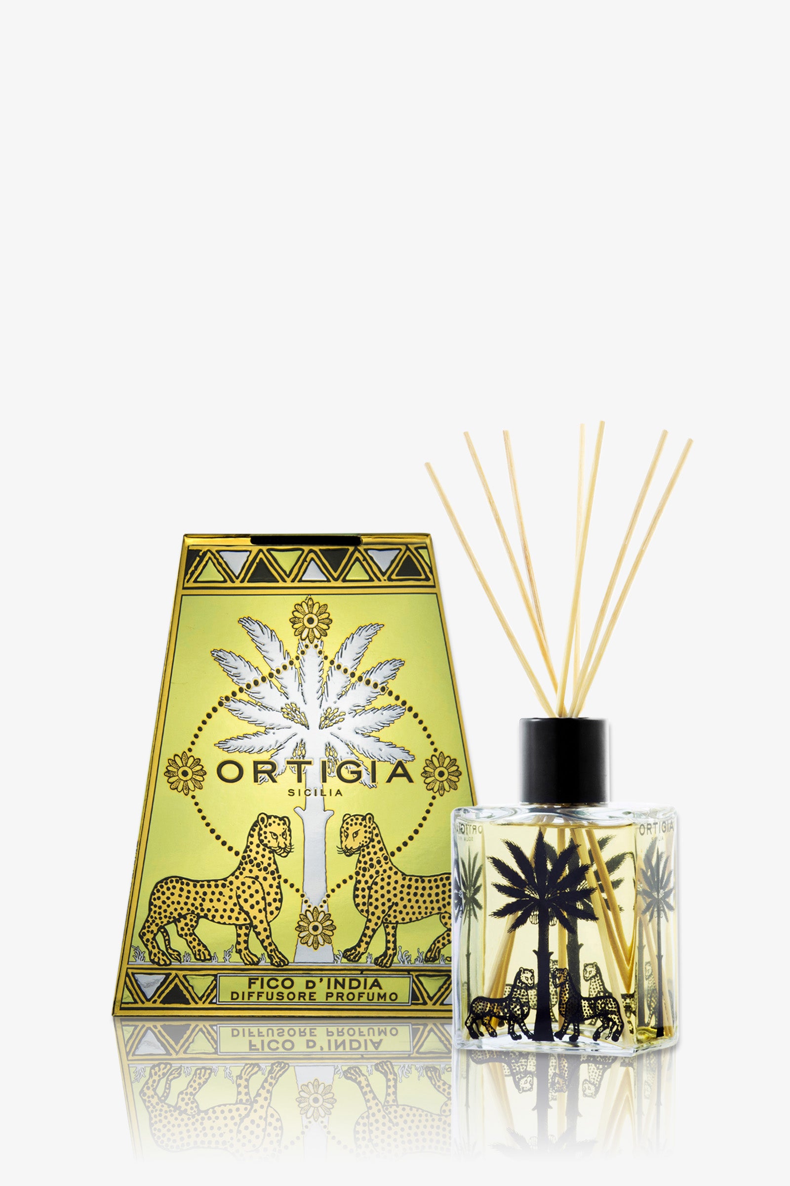 A decorative Ortigia Fico D'India Diffuser in a green box and glass bottle with reed sticks. Both show black palm tree and leopard designs, with "Ortigia" branding. The background is white.