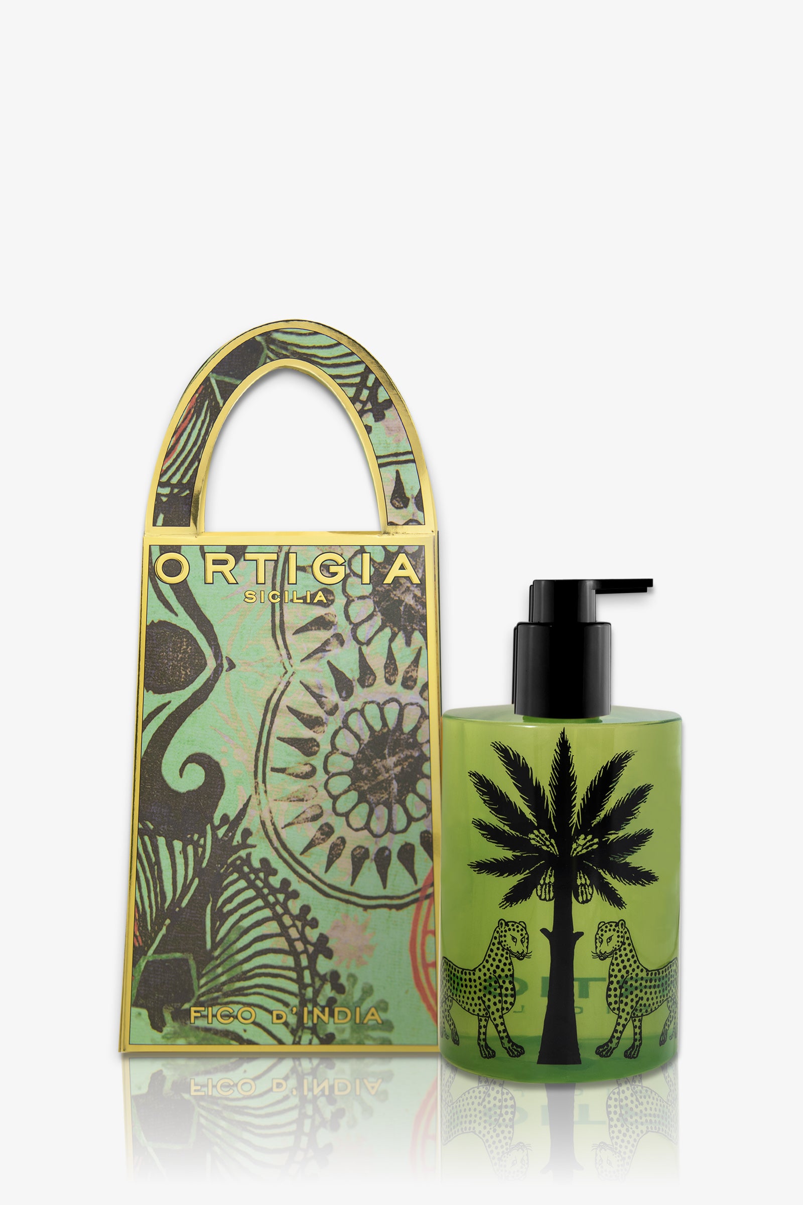 A green Ortigia Fico D'India Hand Soap bottle with a black palm tree and leopard design sits beside a matching decorative box featuring gold accents and floral patterns. The label reads "Fico d’India.