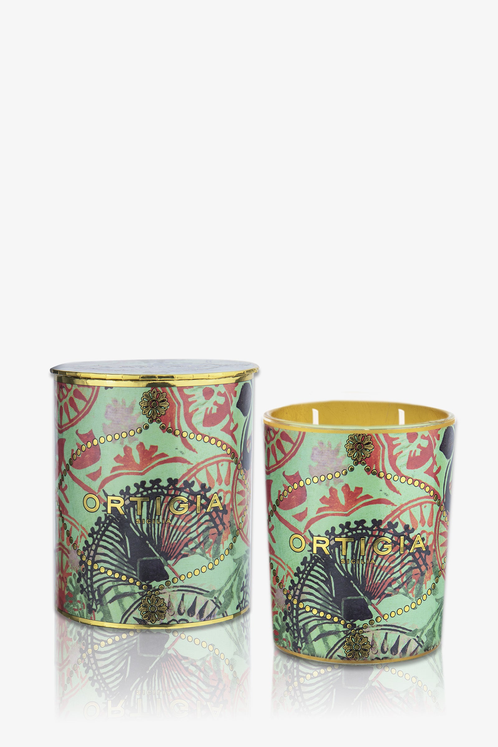 Two Ortigia Fico D'India Medium Candles in green tins with gold lids, showcasing intricate red, black, and gold palm leaf patterns and the Ortigia brand name on the front.