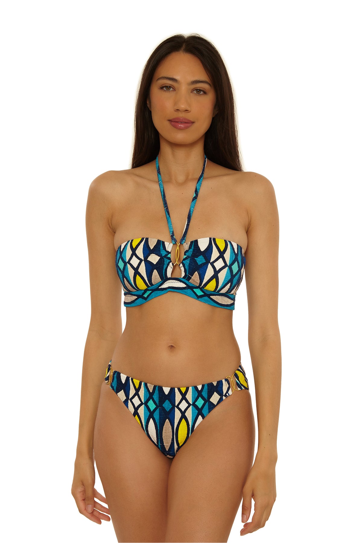 A woman with long brown hair wears the Paros Banded Bandeau Top featuring a blue, yellow, and white geometric print, standing against a plain white background.