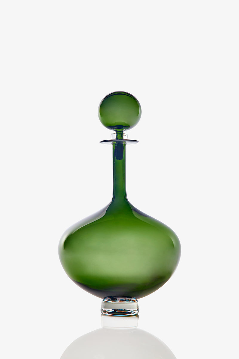 The Petite Genie Bottle Decanter is a green glass decanter with a round stopper, wide base, and narrow neck, shown against a plain white background.