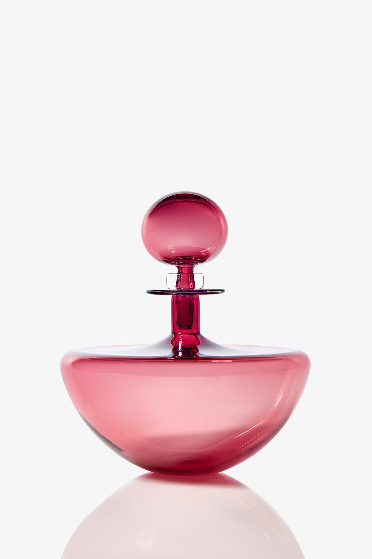 The Small Angelic Bottle is a pink, rounded perfume bottle with a matching spherical cap, displayed against a white background.
