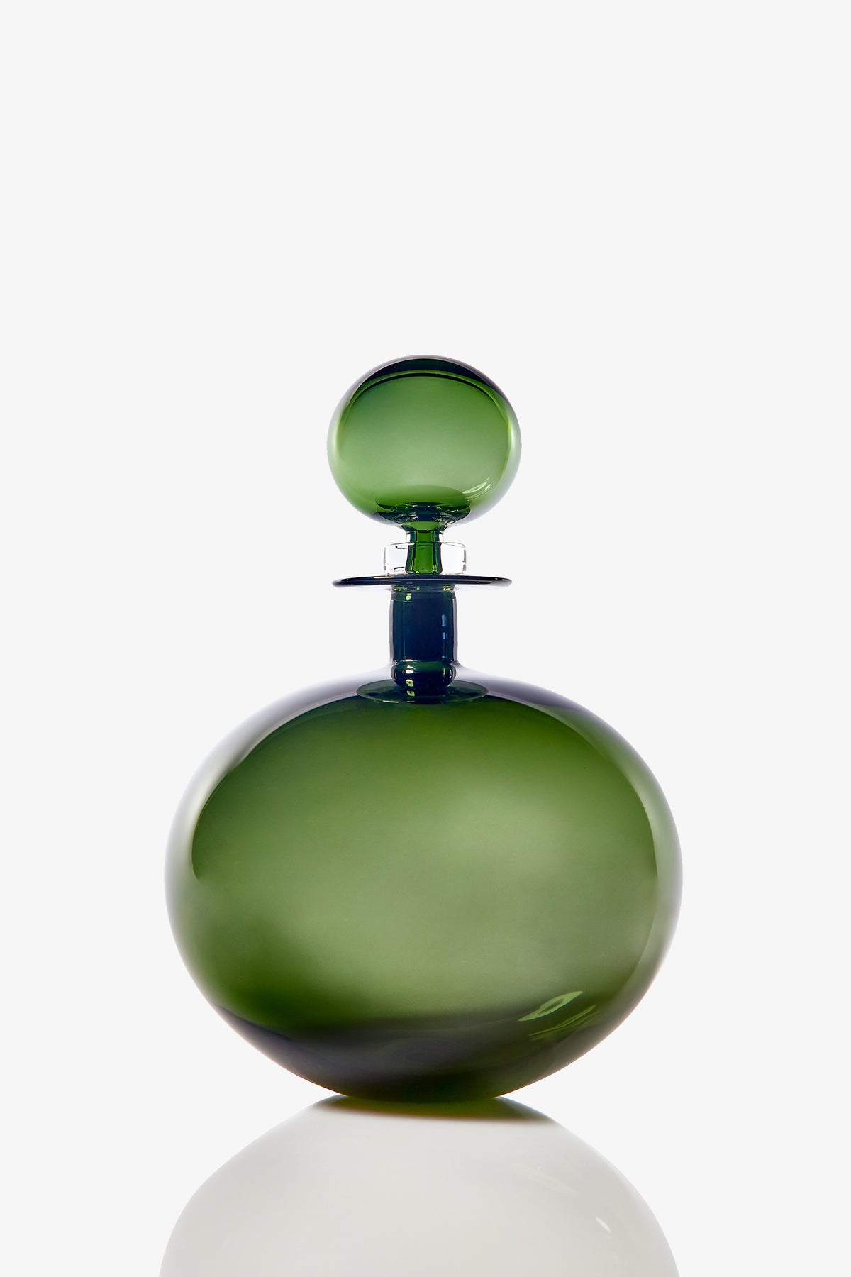 The Small Angelic Bottle is a round, green glass perfume bottle with a matching spherical stopper, displayed on a white background with a subtle reflection at its base.