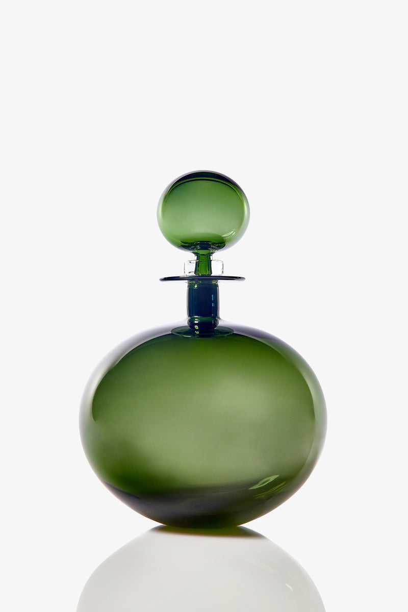 The Small Angelic Bottle is a round, green glass perfume bottle with a matching spherical stopper, displayed on a white background with a subtle reflection at its base.