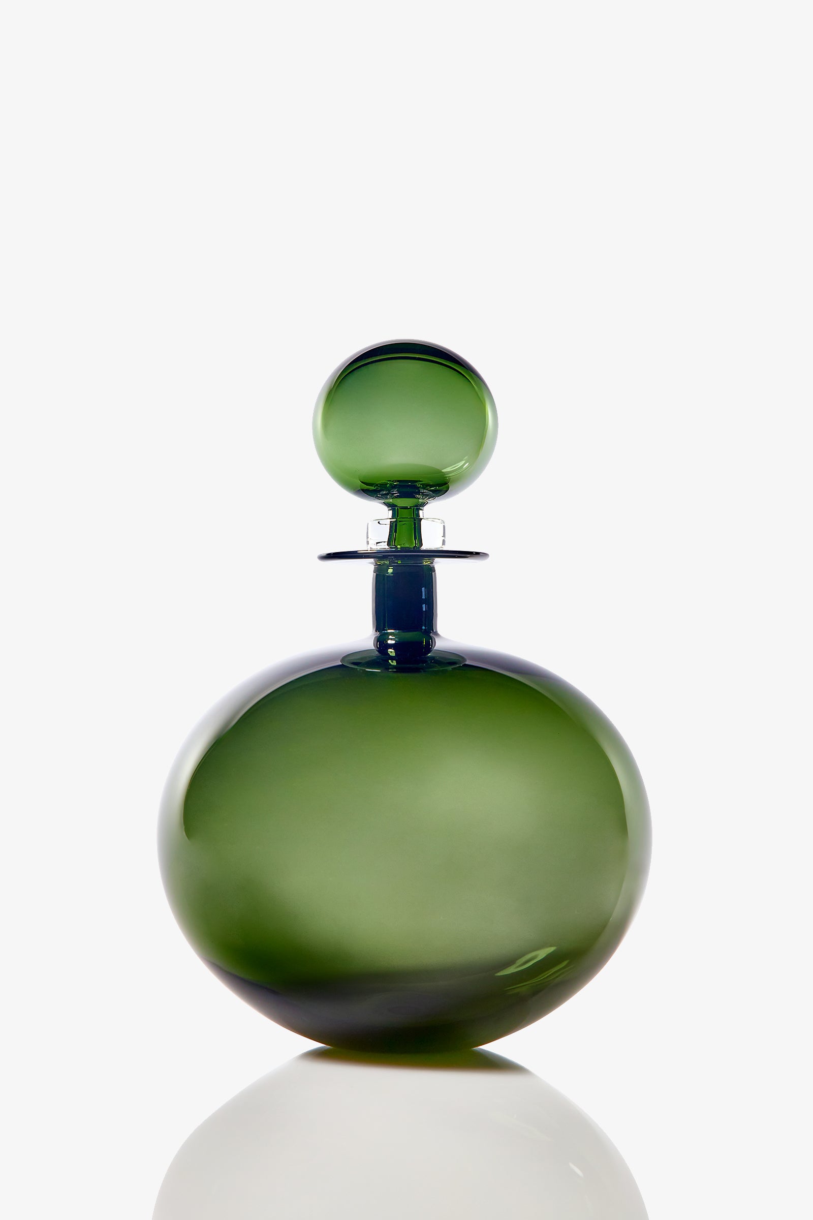 The Small Angelic Bottle is a round, green glass perfume bottle with a matching spherical stopper, displayed on a white background with a subtle reflection at its base.