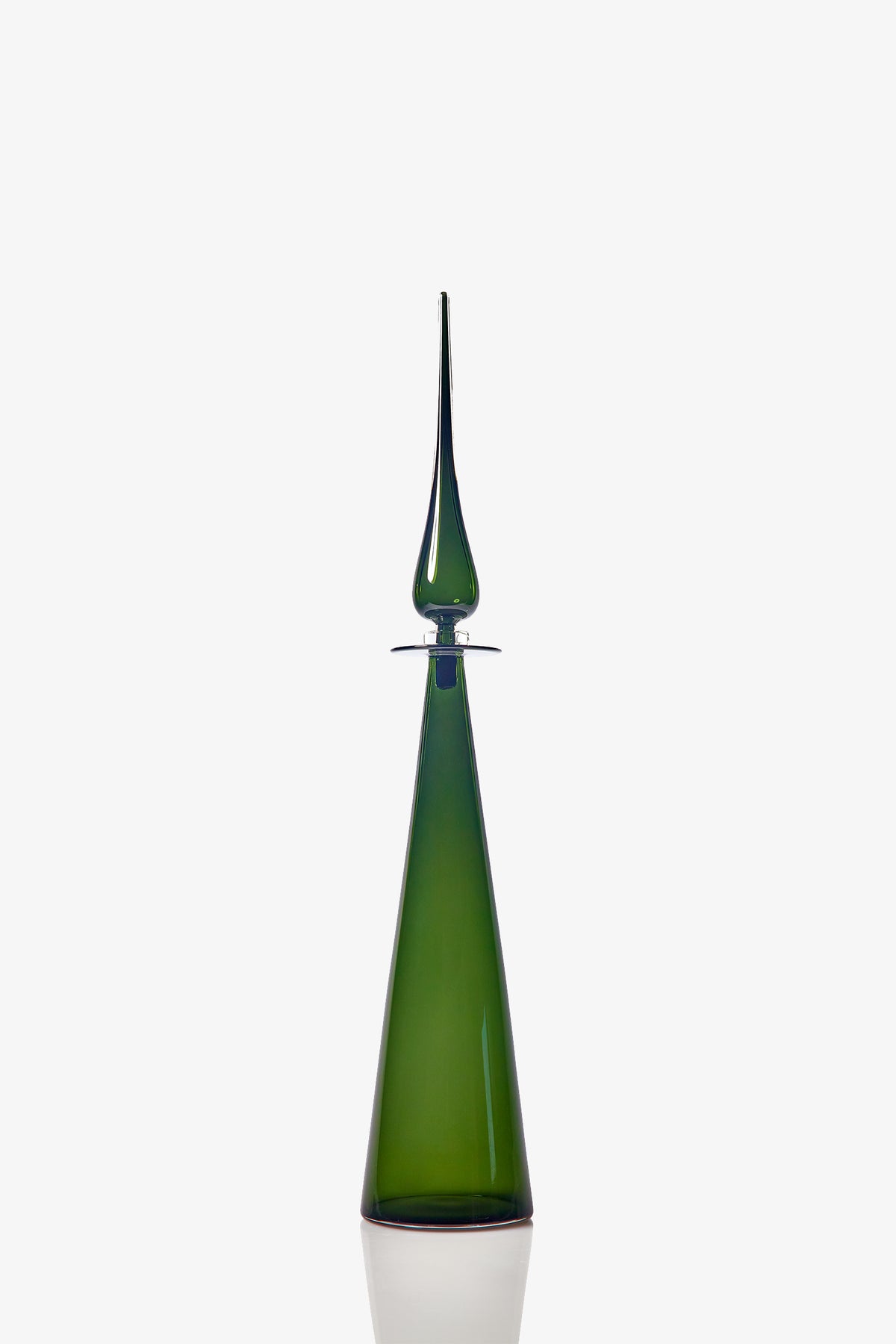 The Petite Straight Cone Decanter, a tall and elegant green glass bottle featuring a long, pointed stopper, is showcased against a plain white background.