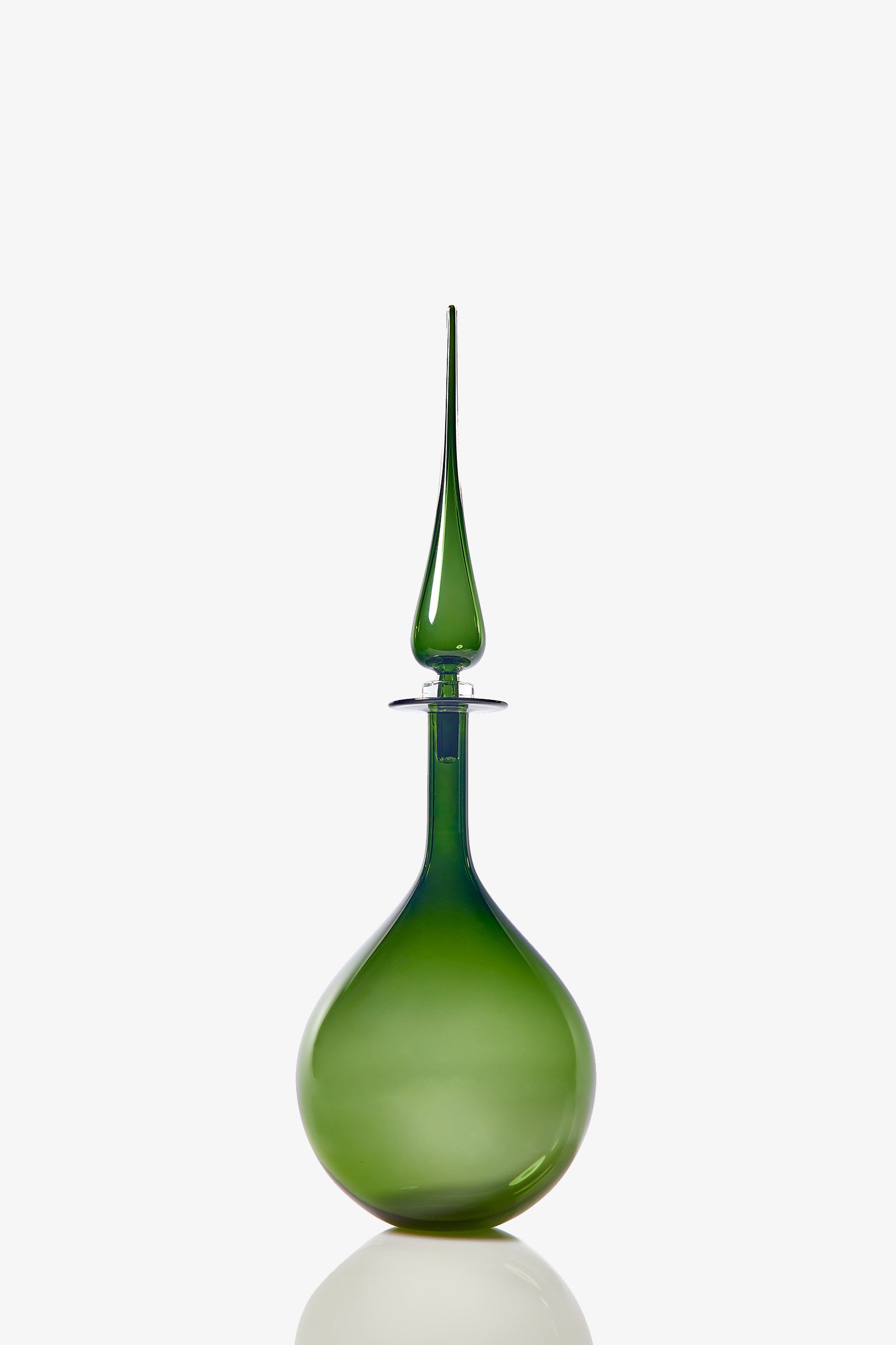 The Petite Tear Drop Decanter features a sleek, green glass design with a round base and long, pointed stopper. Its glossy, translucent finish stands out against a plain white background.