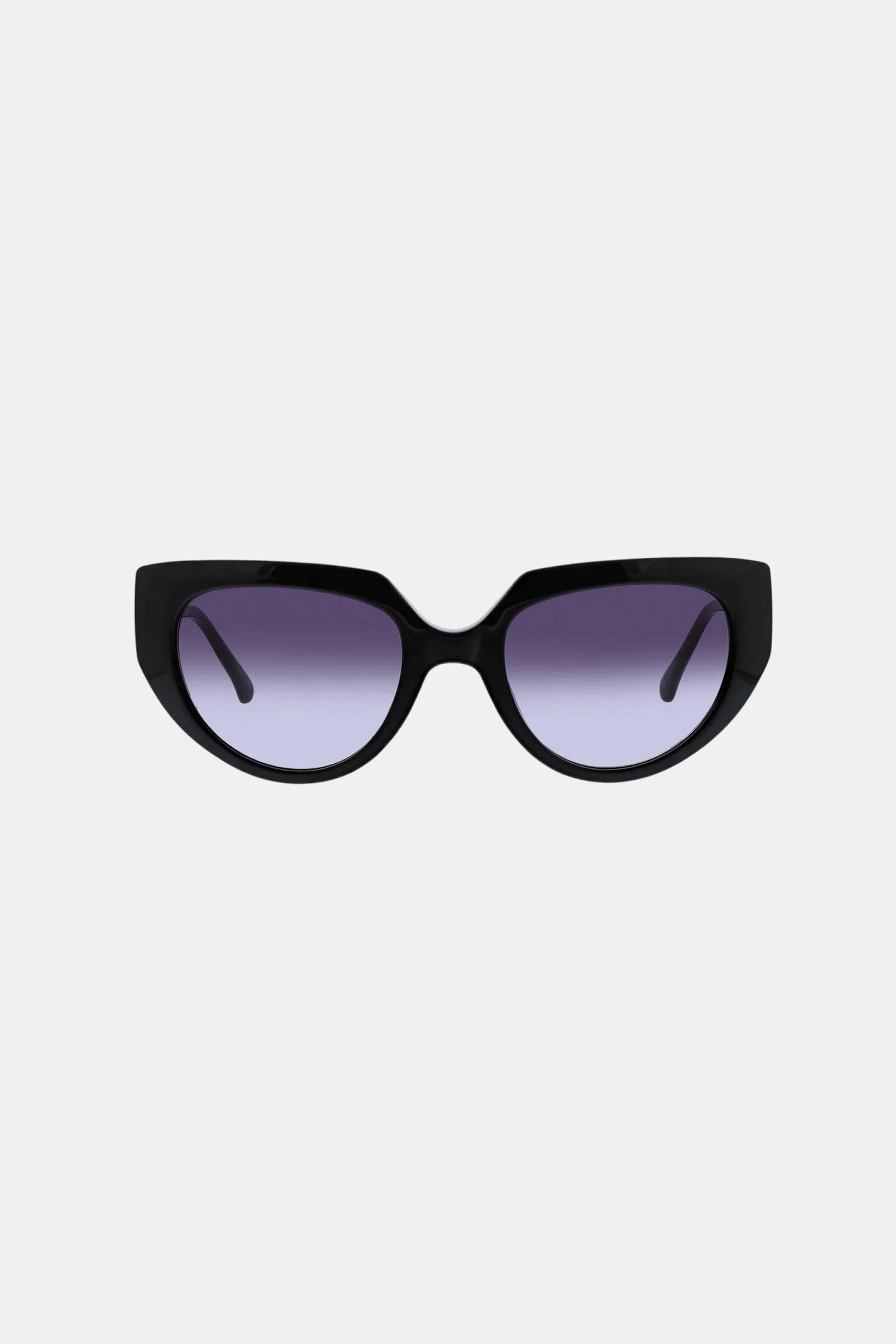 The Schooner Sunglass features black cat-eye frames with thick edges and gradient purple lenses, showcased on a plain light gray background.
