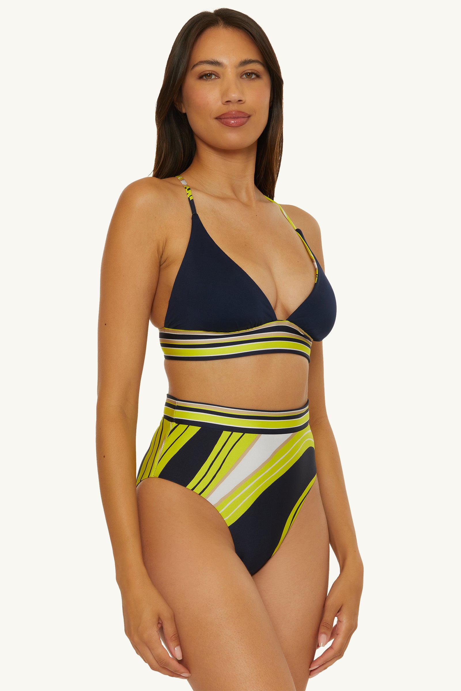 A woman wearing the Serena Swirl Reversible Halter Swim Top stands and smiles slightly against a plain light background.