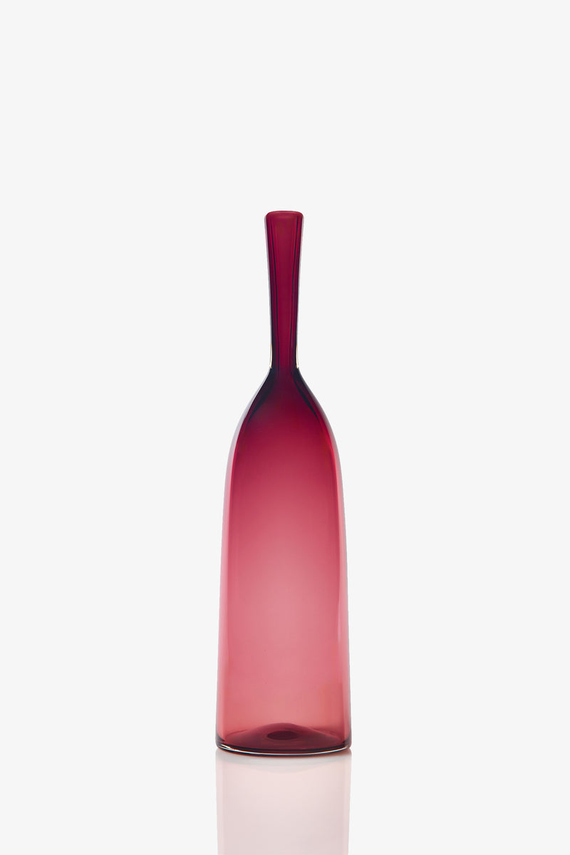 The Small Angelic Bottle is a minimalist, tall translucent glass bottle with a narrow neck and a deep red gradient, displayed on a plain white background.