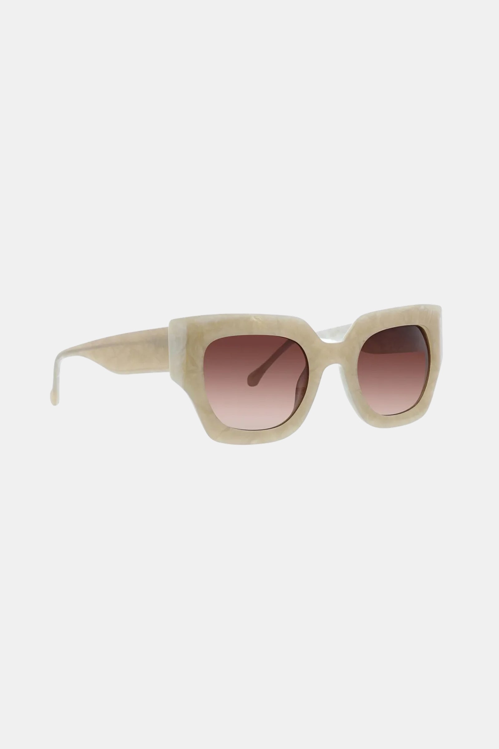 Sol Sunglass features beige, thick frames with a subtle cat-eye design and pink-tinted lenses, showcased against a plain white background.