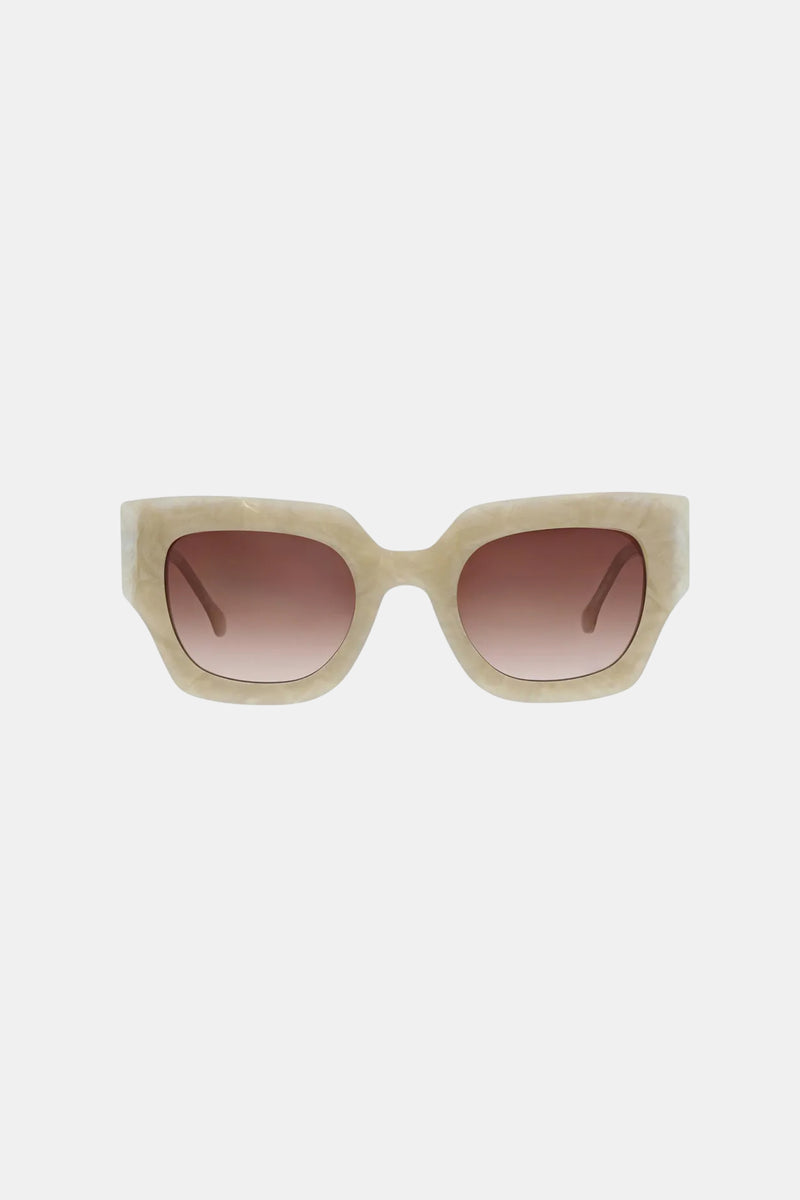 The Sol Sunglass features beige thick square frames and brown gradient lenses, shown against a plain white background.