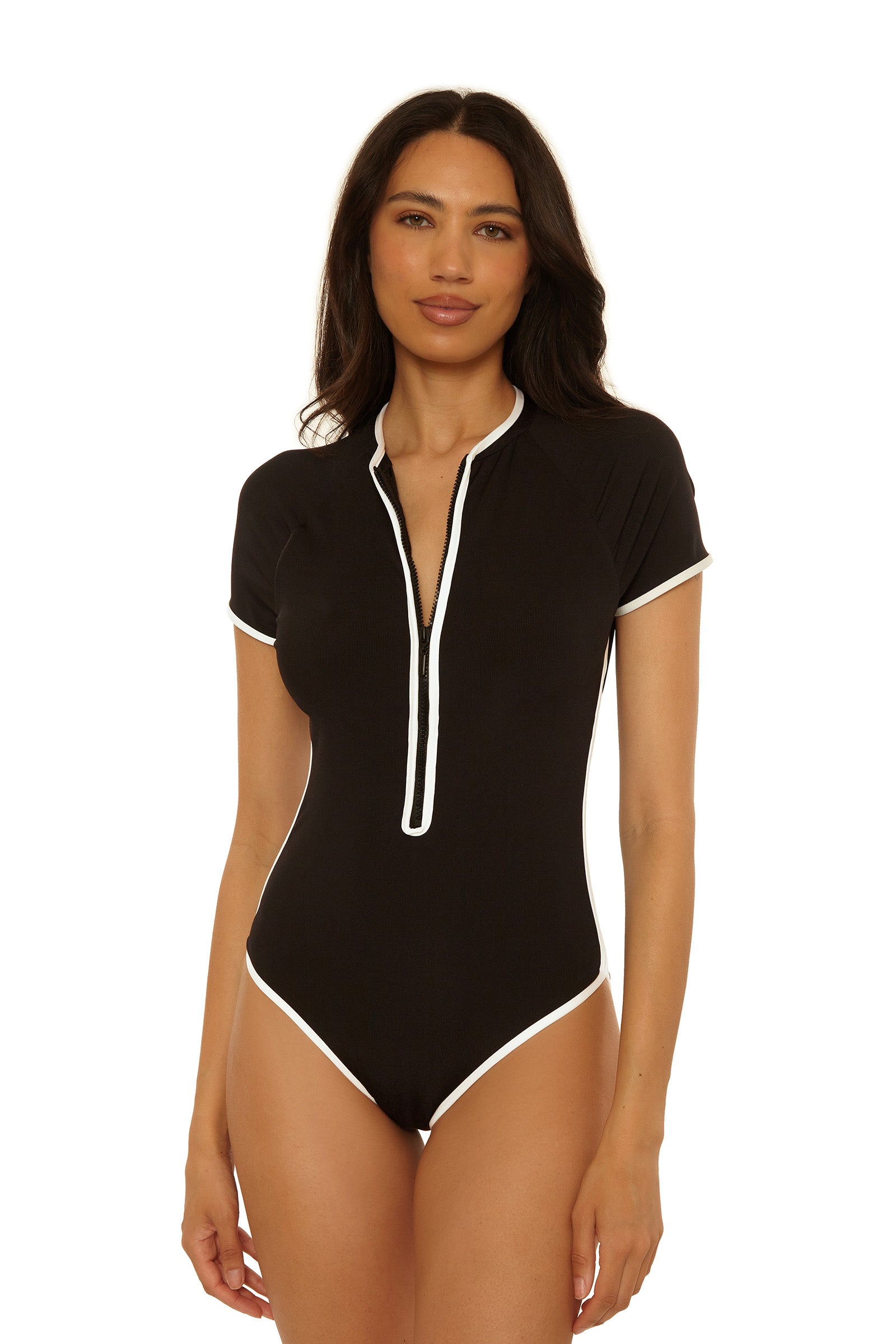 A woman poses against a white background wearing the Triumph Short-Sleeve Zip-Up Paddlesuit in black, featuring short sleeves, a front zipper, and white trim along the edges.