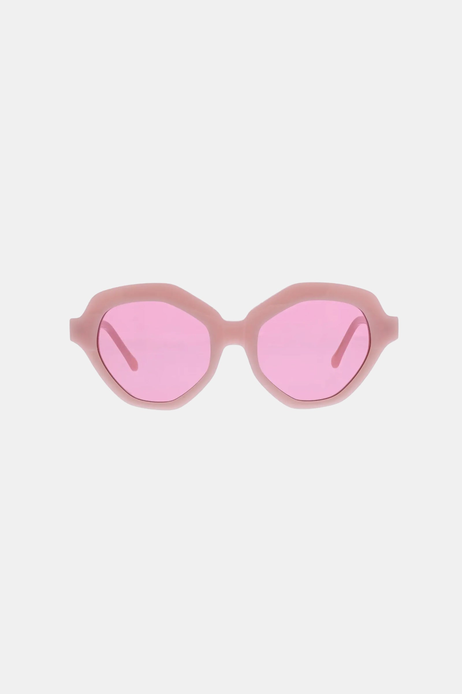 The Ipanema Sunglasses feature oval, slightly geometric pink frames with matching pink-tinted lenses, displayed on a plain white background.