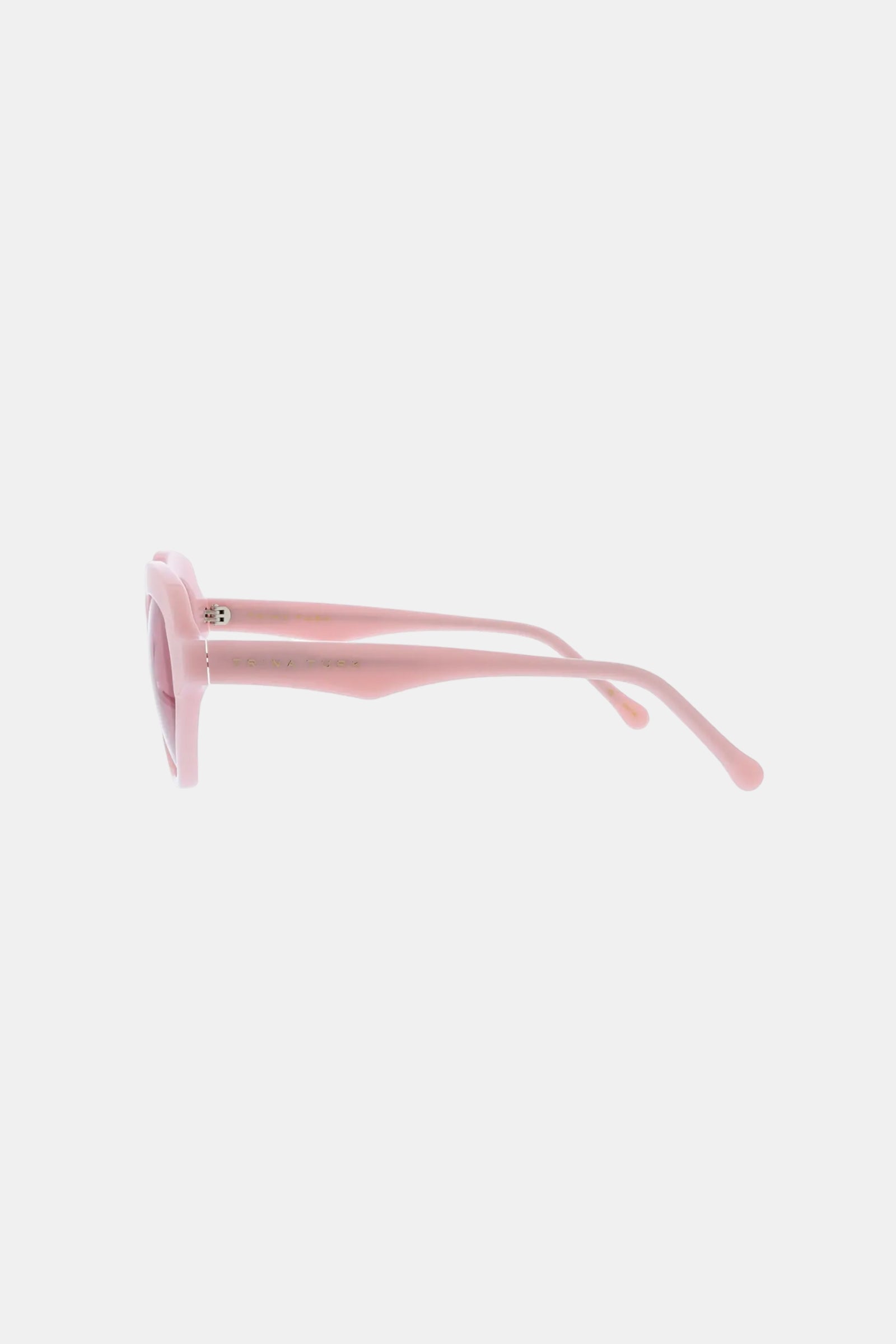 Side view of the Ipanema Sunglasses in pink, featuring thick frames and curved arms, displayed on a plain white background.