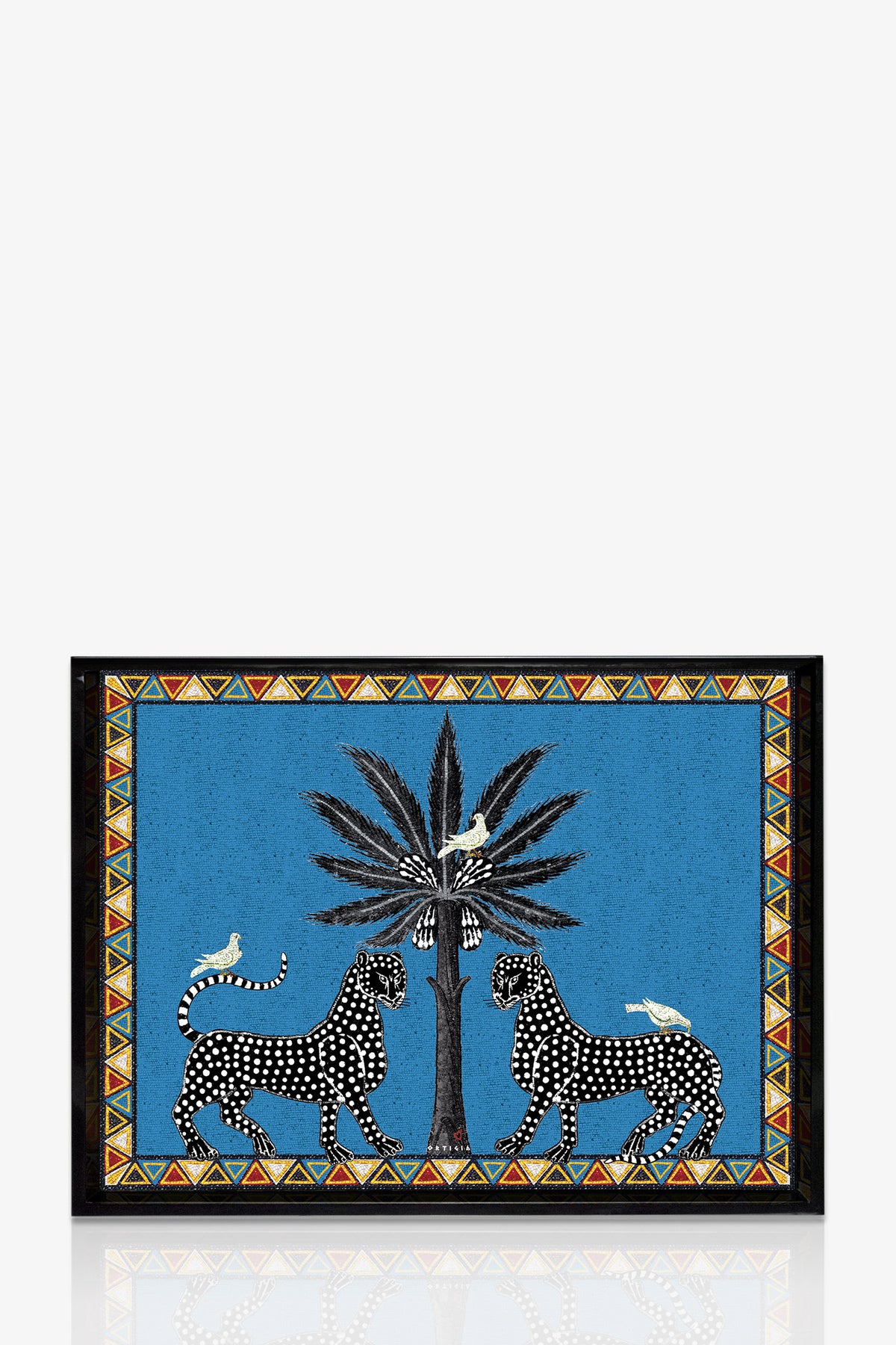 The Ortigia Large Tray displays two black-spotted leopards facing a central palm tree with white birds perched nearby, set against a blue background and bordered by vibrant geometric patterns.