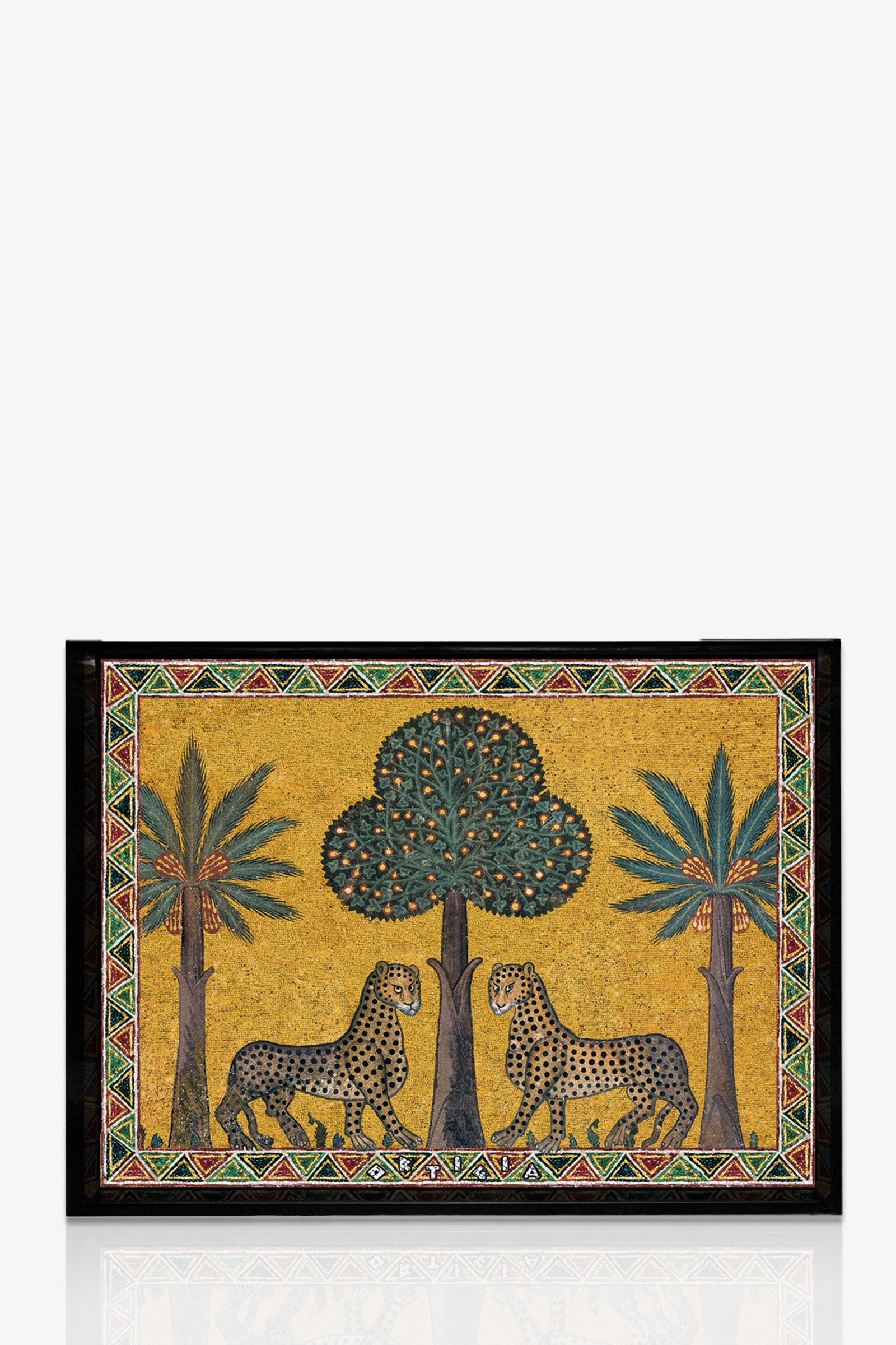 The Ortigia Small Tray features two leopards facing each other beneath a central tree, with palm trees on each side. It has a golden yellow background and a geometric border in red, green, black, and white.