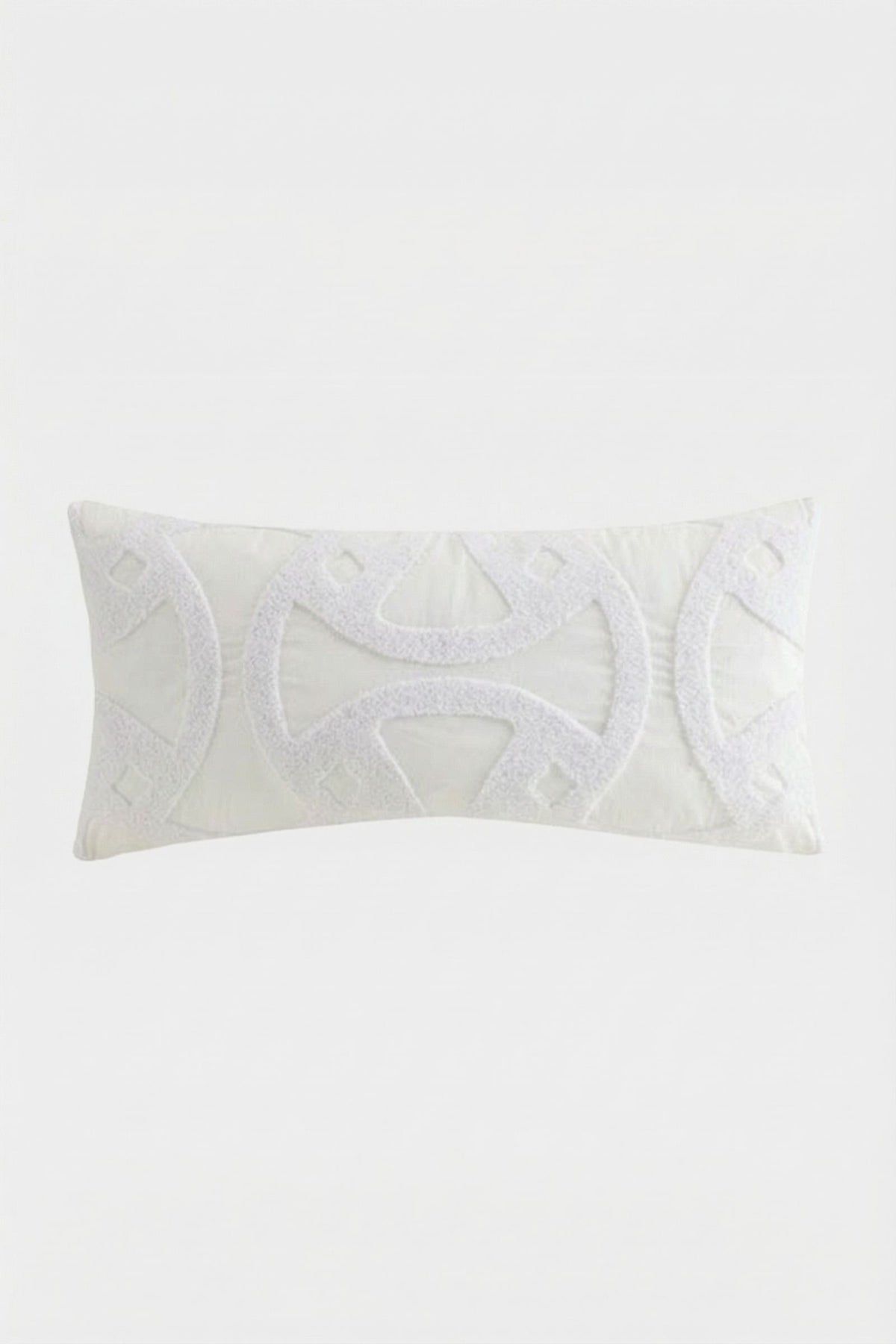 The Santorini White Tufted Throw Pillow 12"X24" features textured geometric patterns and symmetrical curved designs on a plain white background.