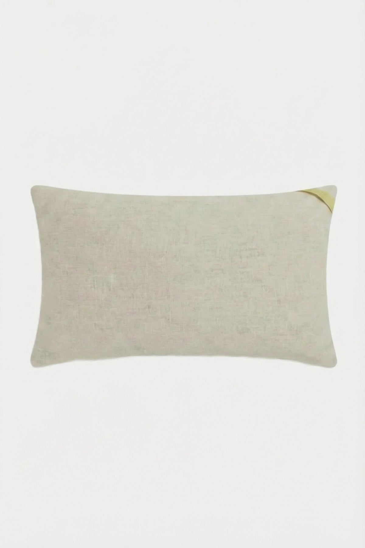 The Amazing Maze Embroidered Pillow is a rectangular, light beige cushion with a subtle texture and a small golden ribbon on one corner, displayed against a white background.