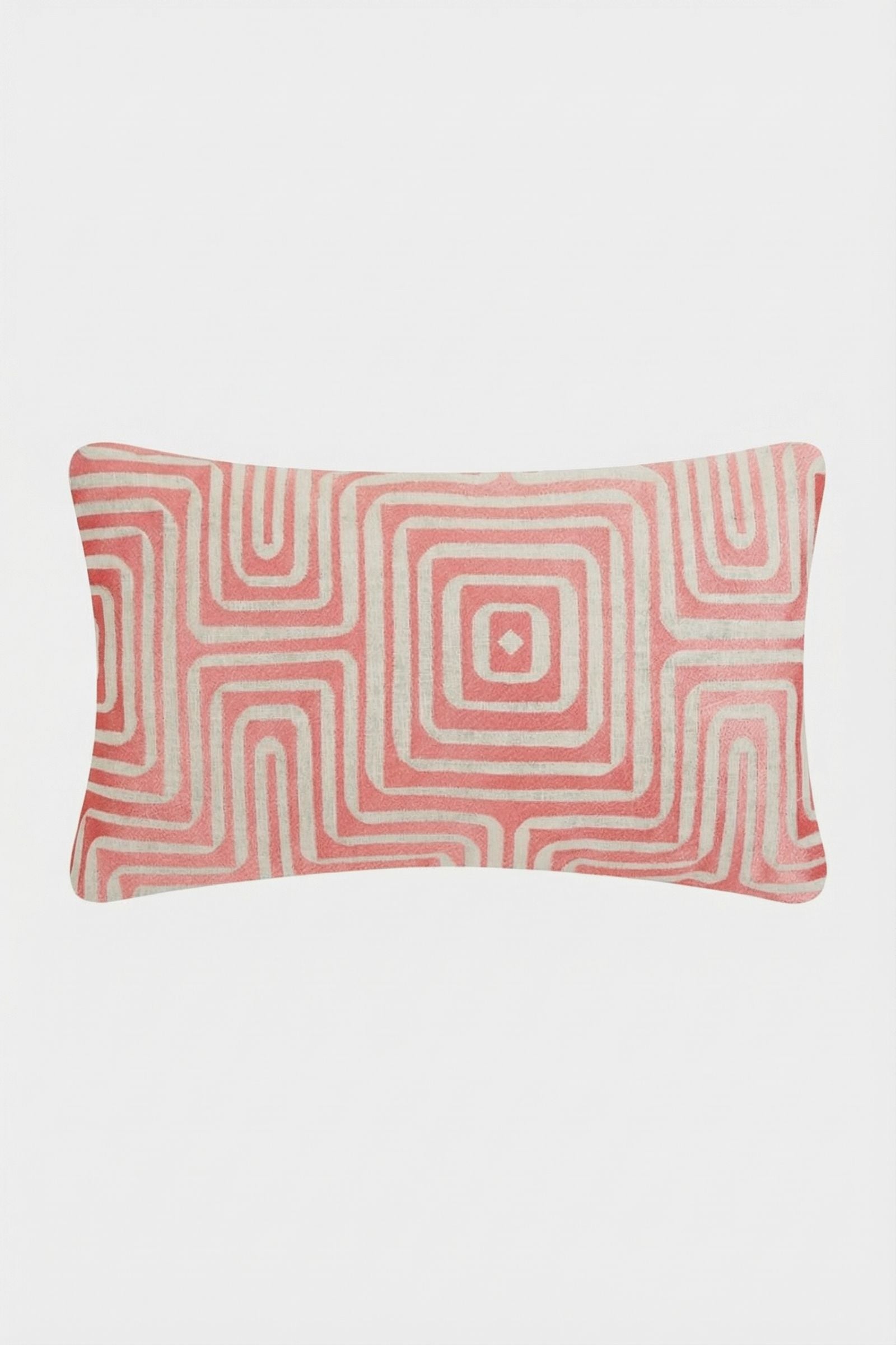 The Amazing Maze Embroidered Pillow features a geometric pattern of concentric squares in pink and off-white on a light background, with slightly rounded edges. Shown against a plain white backdrop.