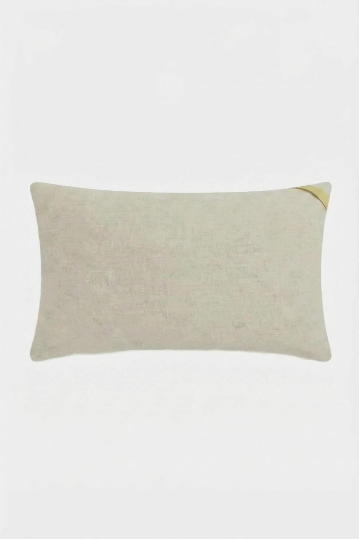 The Calistoga Embroidered Rainbow Lumbar Pillow is a rectangular beige accent pillow with a subtle woven texture and a small diagonal yellow detail on the top right, perfect as a stylish throw pillow for any space.