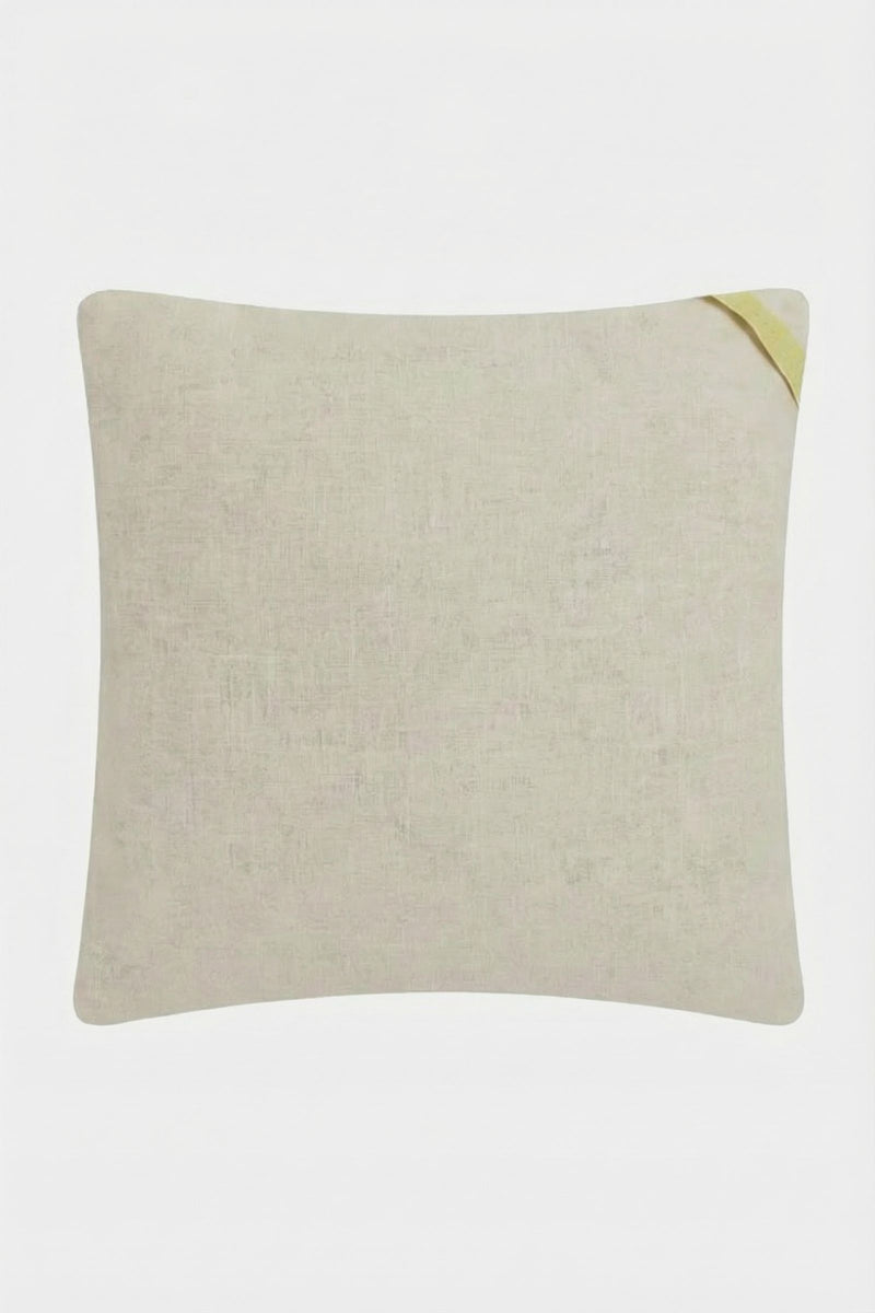 The Costa Mesa Embroidered Throw Pillow is a square, beige cushion with subtle texture and a small yellow fabric detail on the top right corner, set against a plain white background.