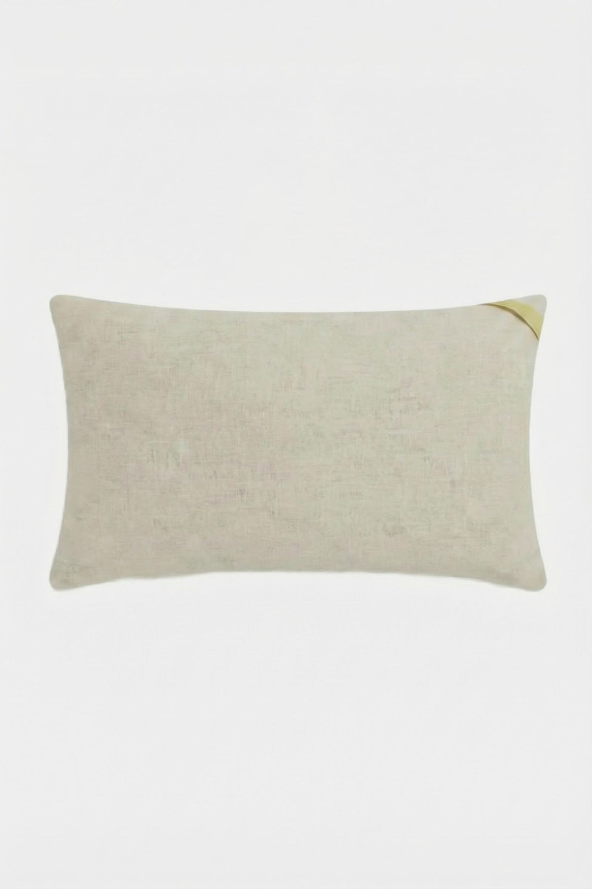 The Escondido Embroidered Lumbar Pillow is a rectangular light beige pillow with a small yellow corner accent, shown on a plain white background.