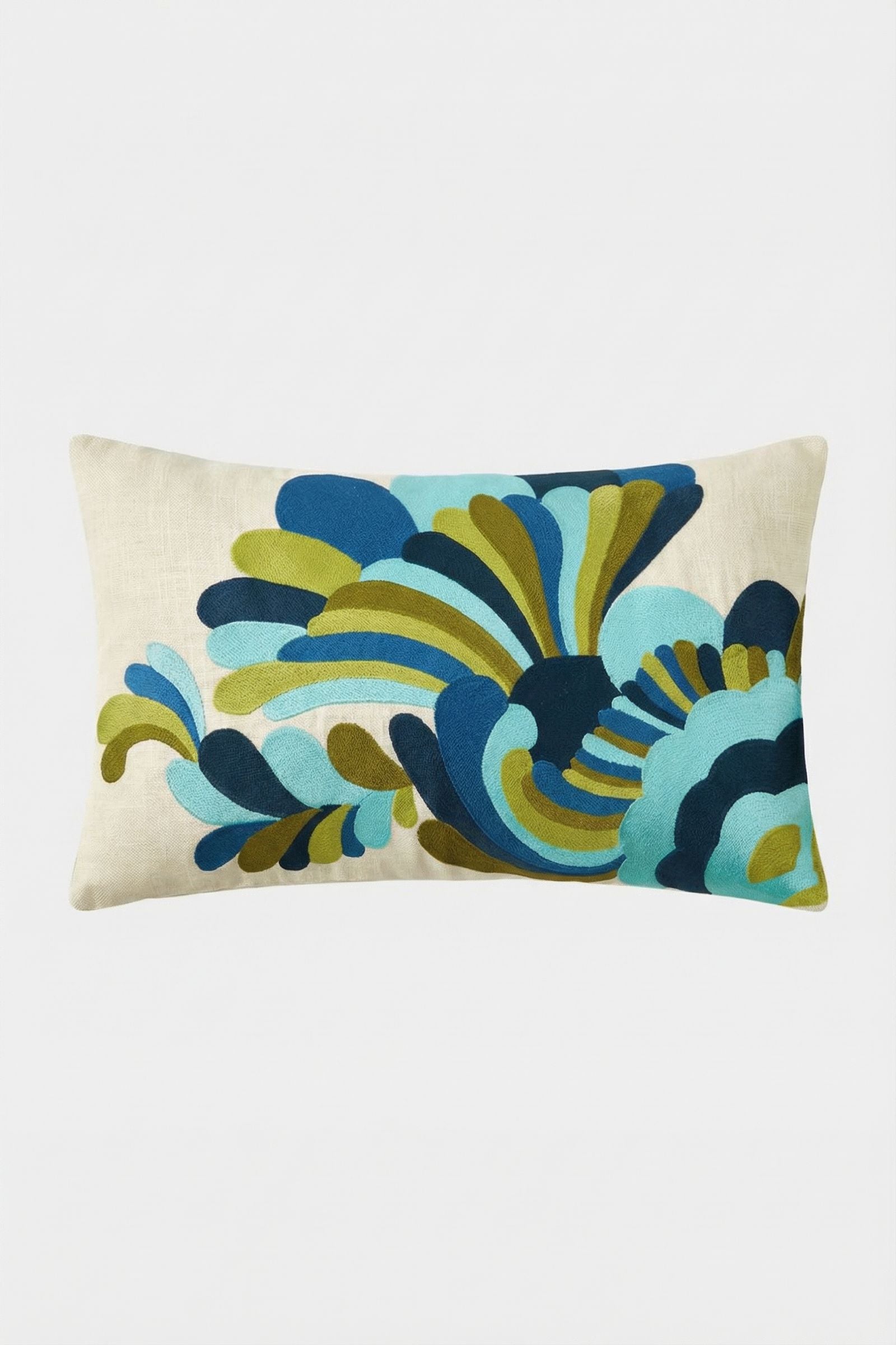 The Escondido Embroidered Lumbar Pillow is a rectangular cream pillow with a bold, abstract floral pattern in blue, green, and teal.