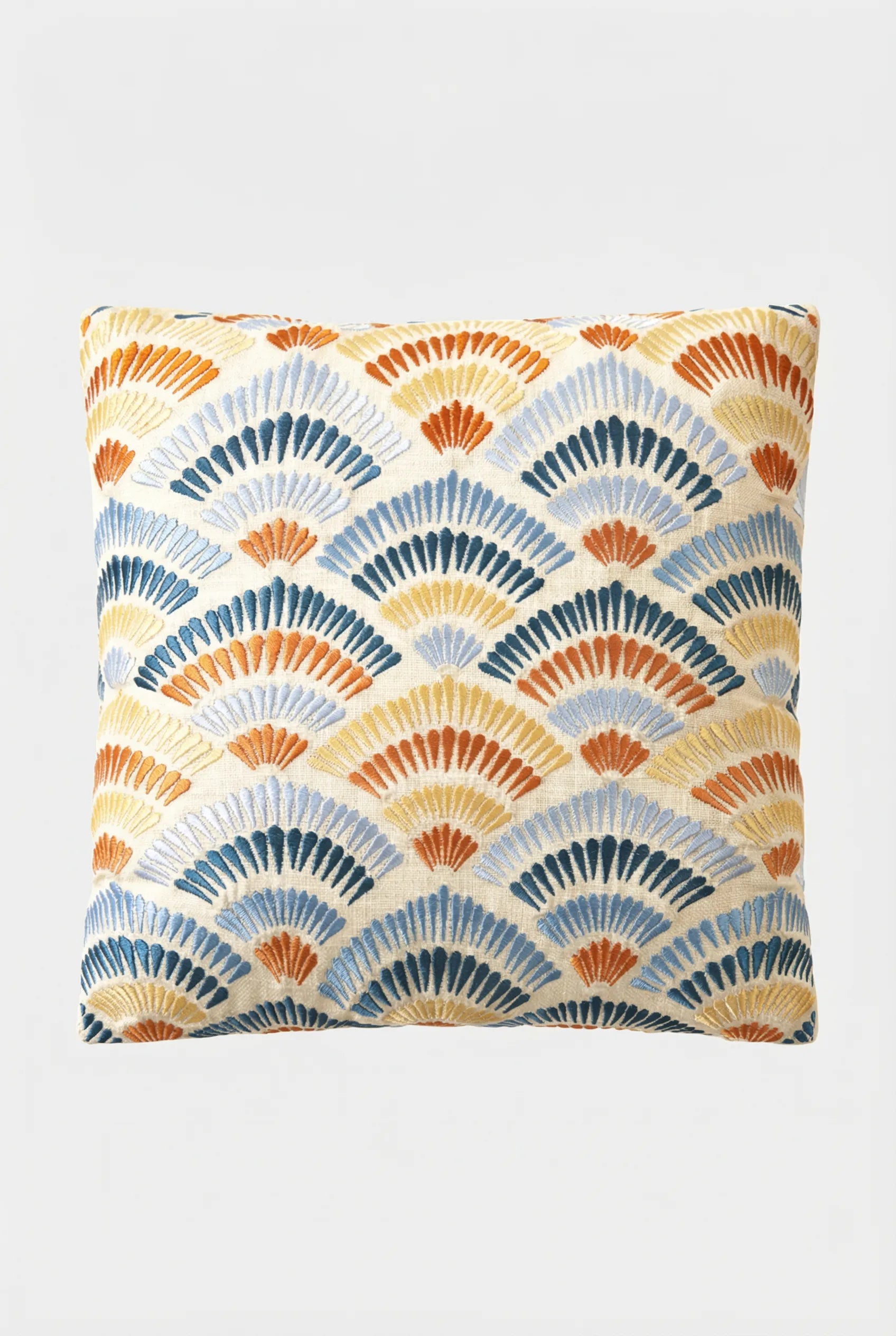 The Pasadena Embroidered Throw Pillow features a repeating fan-shaped pattern in blue, orange, yellow, and beige on white, creating a geometric, art deco-inspired look.