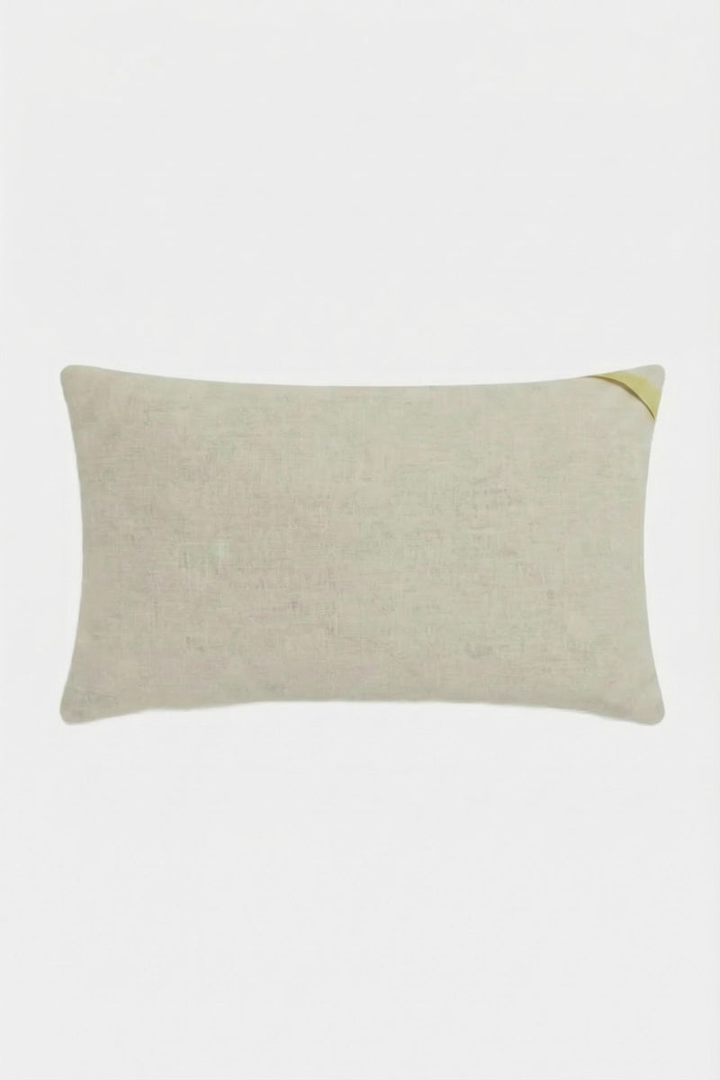 The Roseville Embroidered Lumbar Pillow is a rectangular beige pillow with a subtle texture, shown with a small corner fold at the top right on a plain white background.