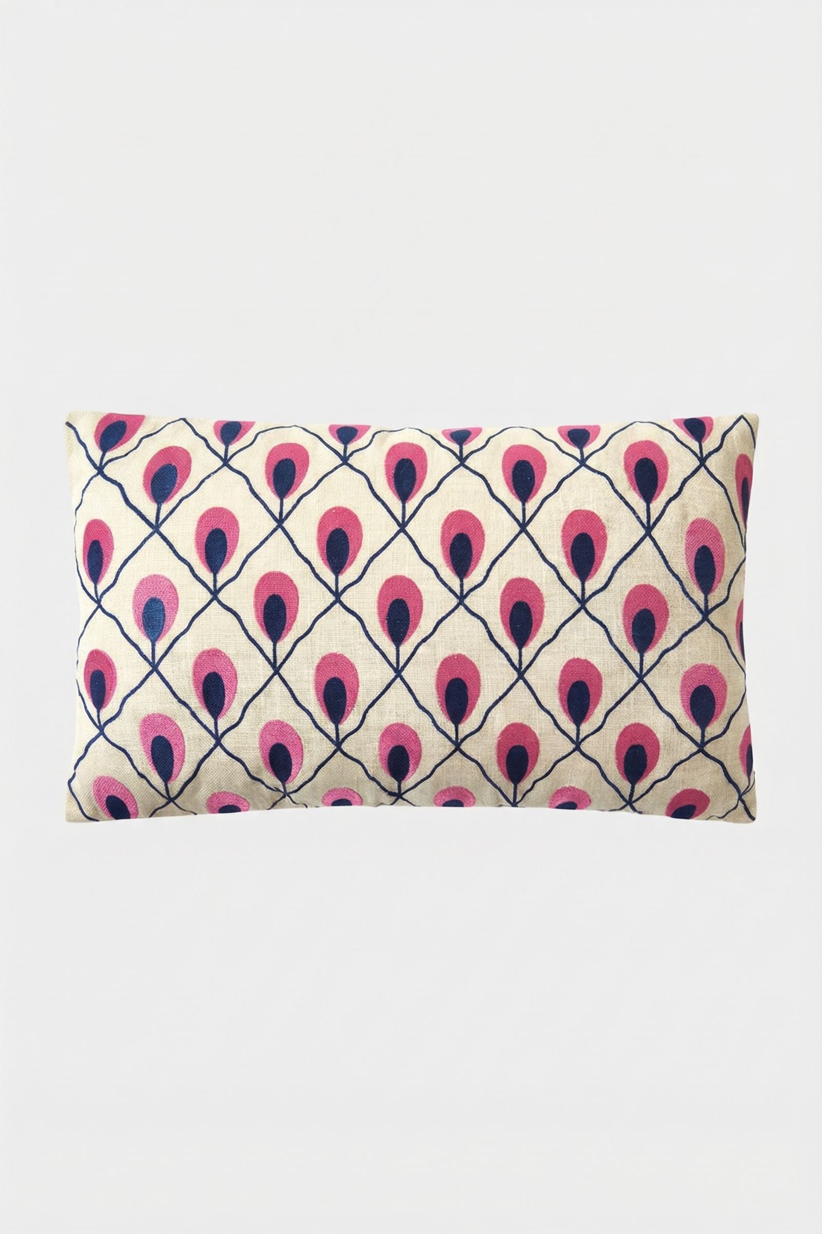 The Roseville Embroidered Lumbar Pillow features a cream background with a geometric pattern of stylized pink and dark blue peacock feathers.