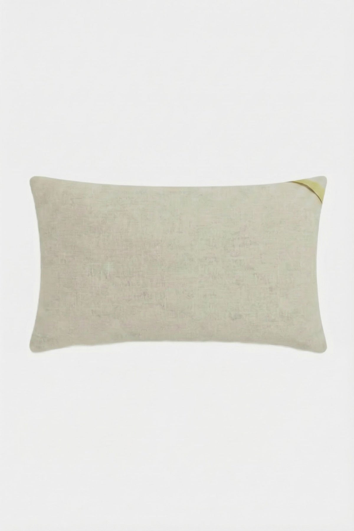 The Roseville Embroidered Lumbar Pillow is a rectangular beige pillow with a subtle texture and a small yellow accent in the top right corner, displayed on a plain white background.