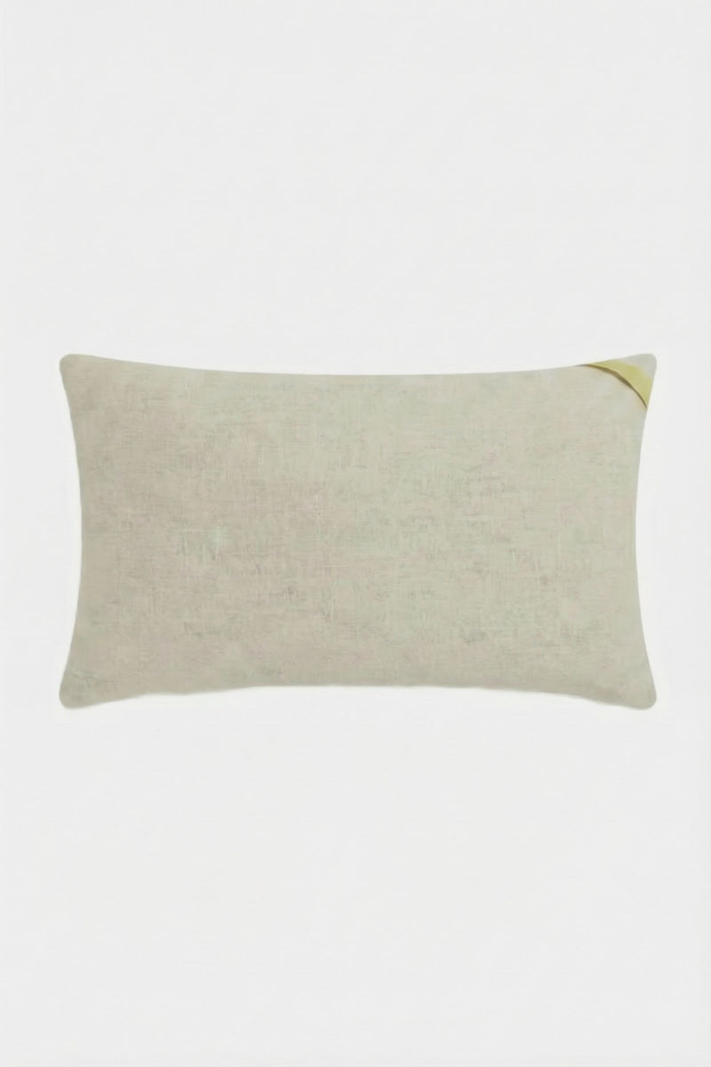 The Roseville Embroidered Lumbar Pillow is a rectangular beige pillow with a subtle texture and a small yellow accent in the top right corner, displayed on a plain white background.