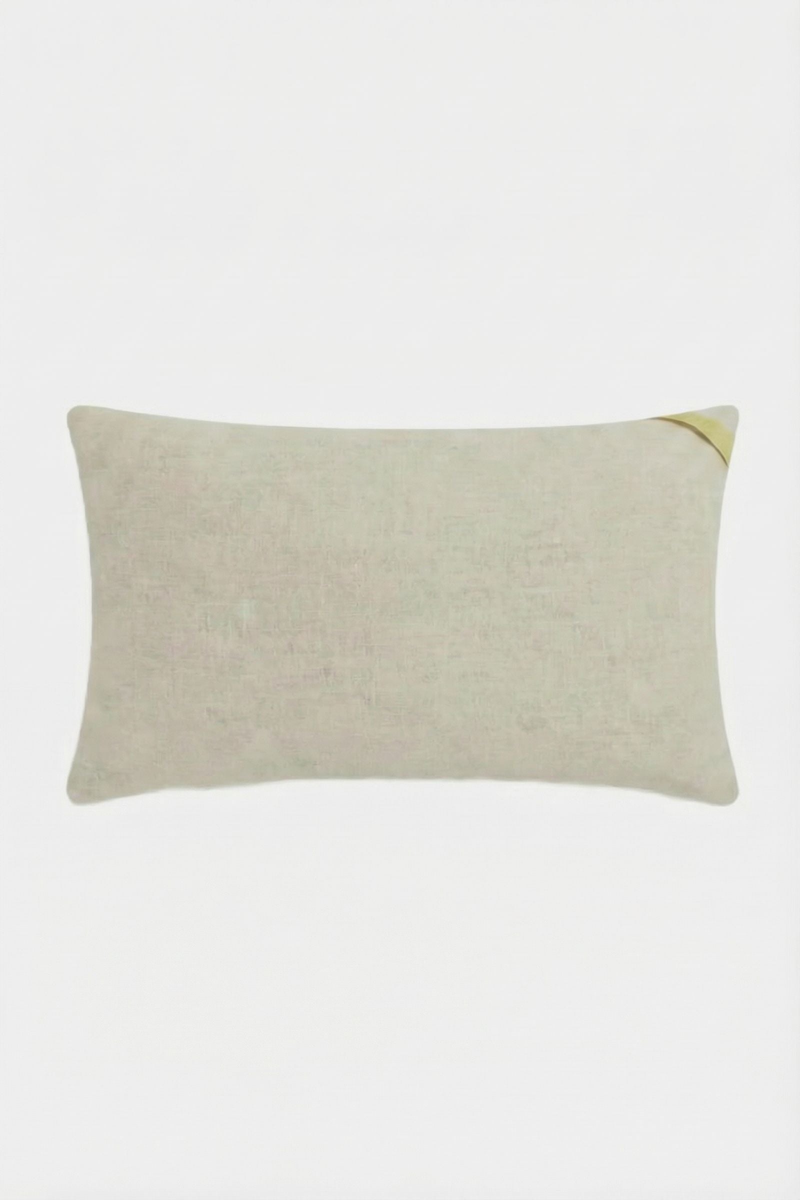 The Roseville Embroidered Lumbar Pillow is a rectangular beige cushion with subtle texture and a small gold accent in one corner, shown against a plain white background.