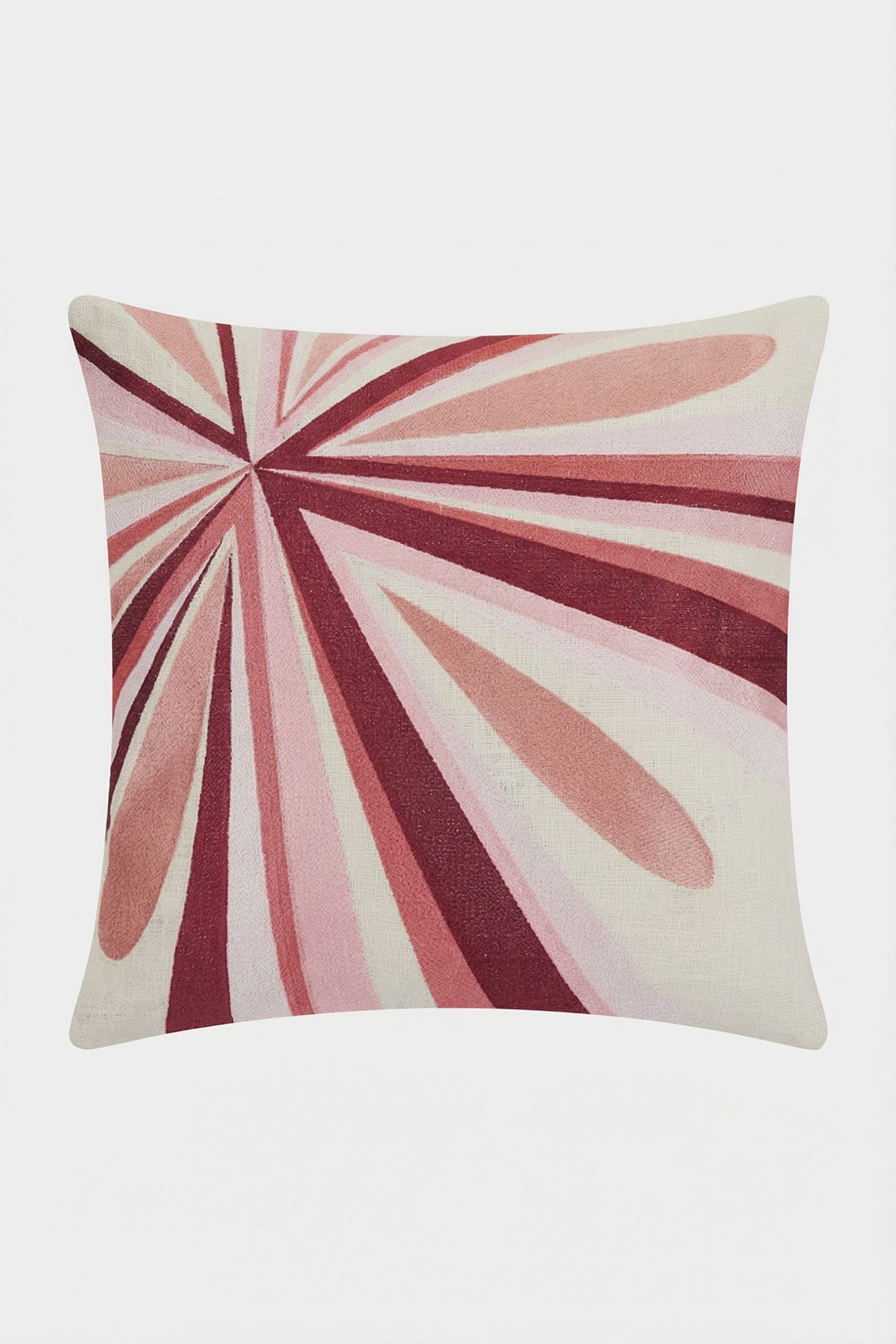 The Shante Embroidered Pillow features an abstract, radiating pattern in pink, red, and burgundy on light beige, with elongated tapered shapes spreading from one corner.
