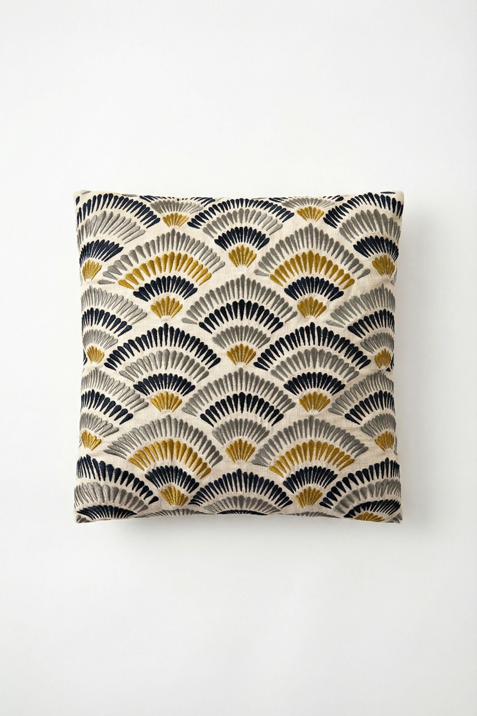 The Pasadena Embroidered Throw Pillow features an art deco-inspired fan pattern in black, gold, and cream on a light beige background, shown against a plain white surface.