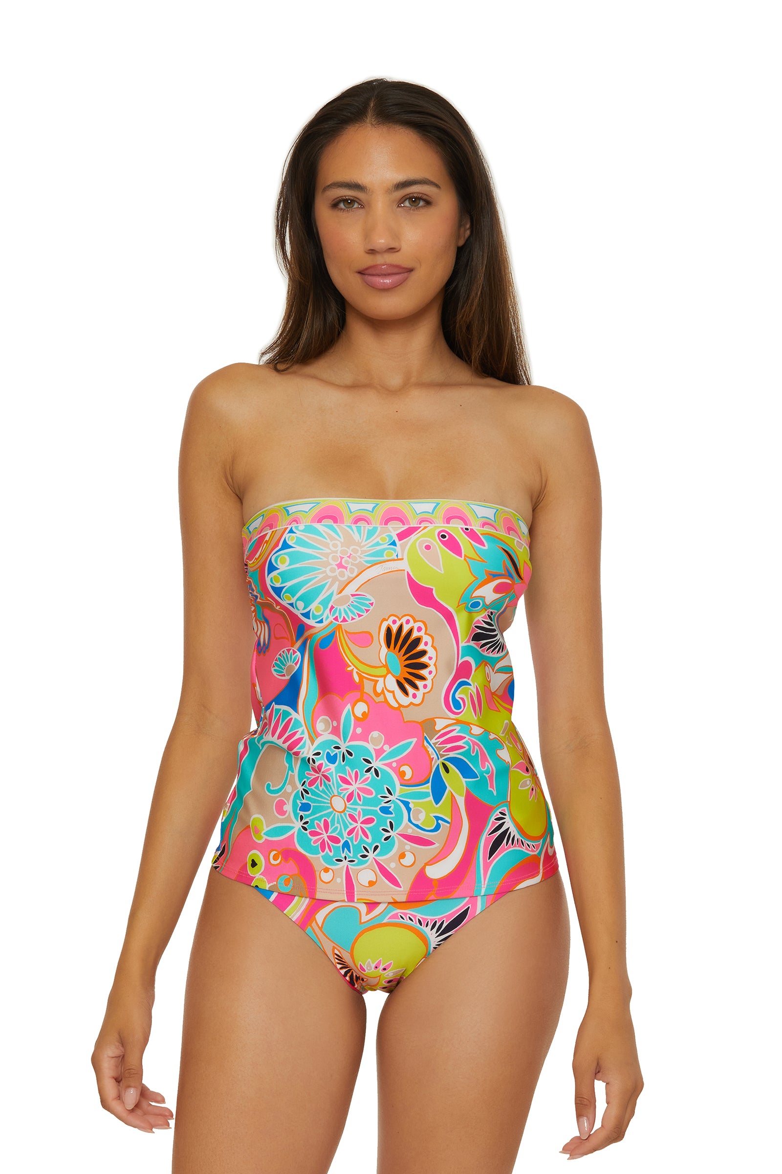 A woman wears the Banded Tankini Swim Top in Venus Swim, featuring a vibrant floral and abstract pattern, standing against a plain white background.