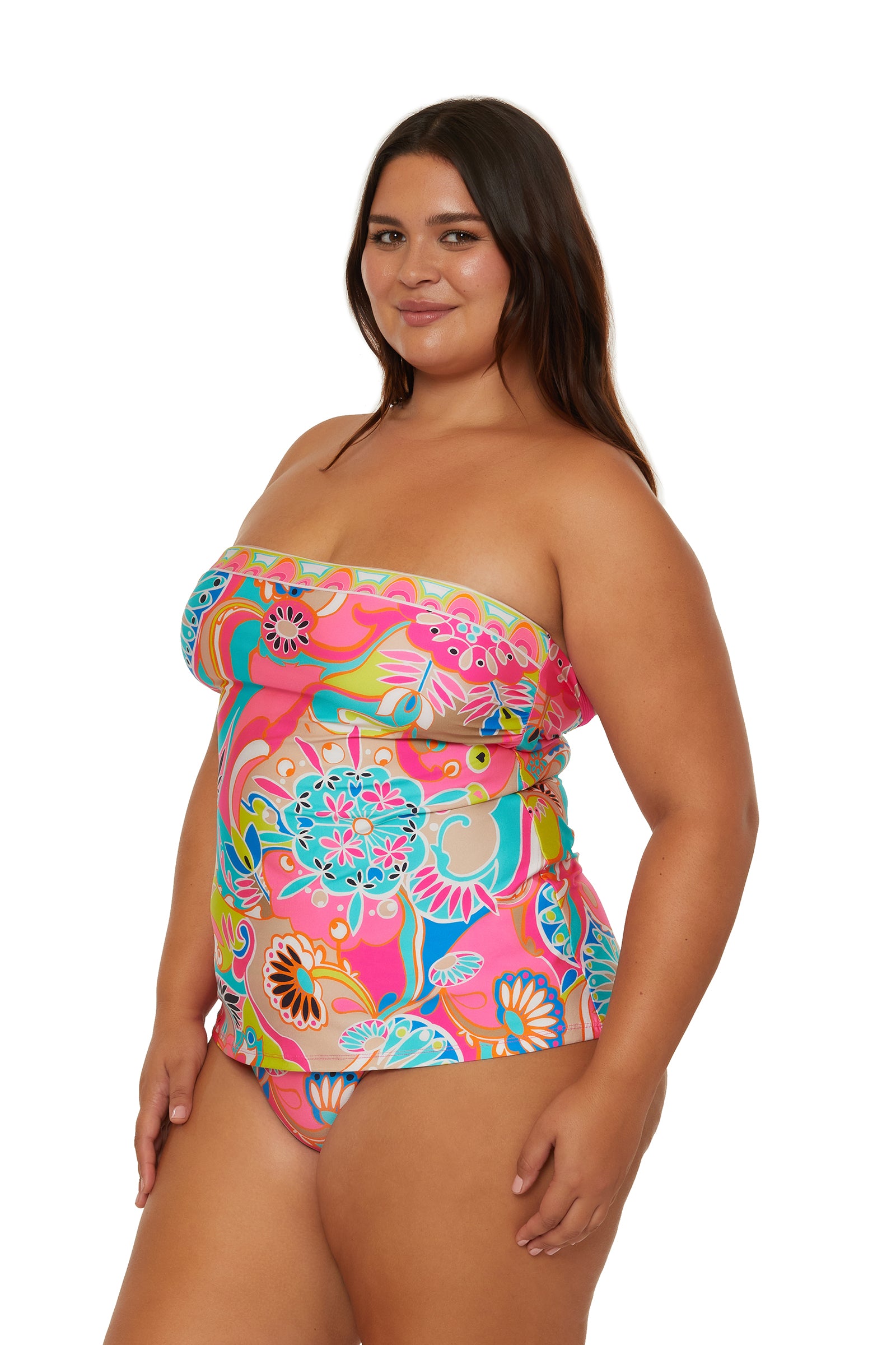 A woman wearing the Venus Banded Tankini Swim Top poses and smiles against a white background.