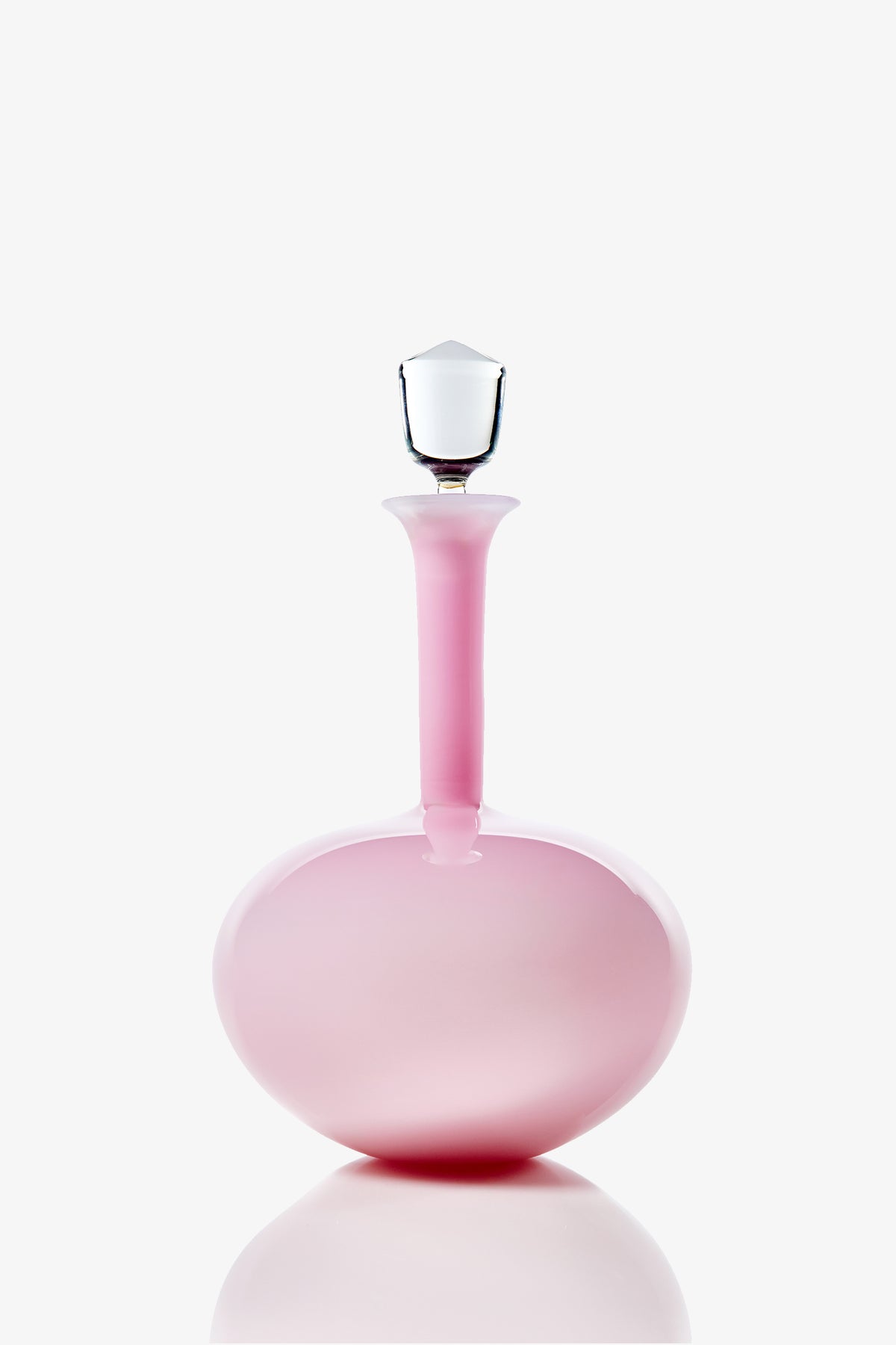 A Wexler Low Oval Bottle in pink glass, featuring a rounded base, a long narrow neck, and a clear faceted stopper, photographed against a white background.